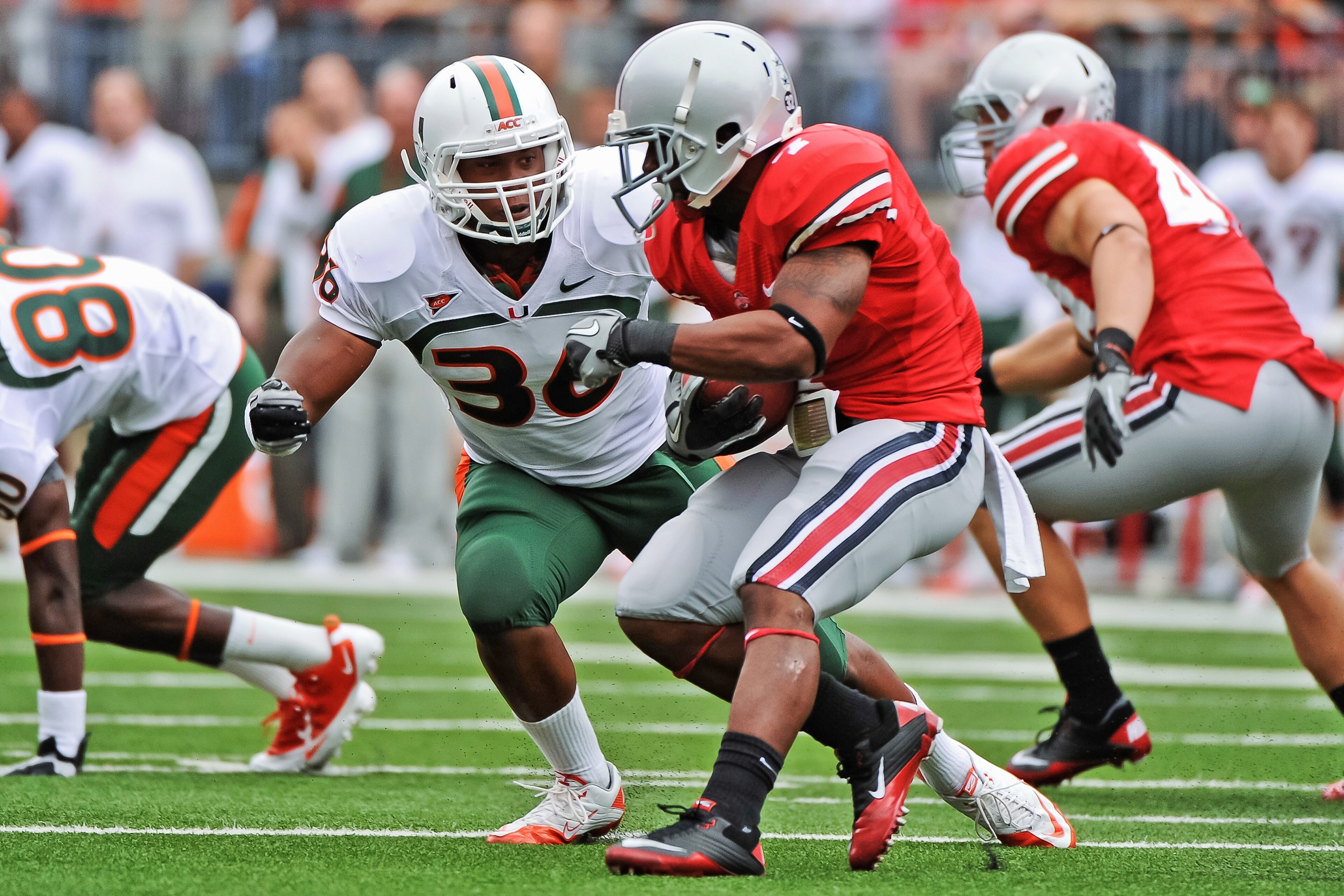 COLUMBUS, OH - SEPTEMBER 11:  Kylan Robinson #36 of the Miami Hurricanes tackles Jordan Hall #7 of the Ohio State Buckeyes  at Ohio Stadium on September 11, 2010 in Columbus, Ohio.  (Photo by Jamie Sabau/Getty Images)