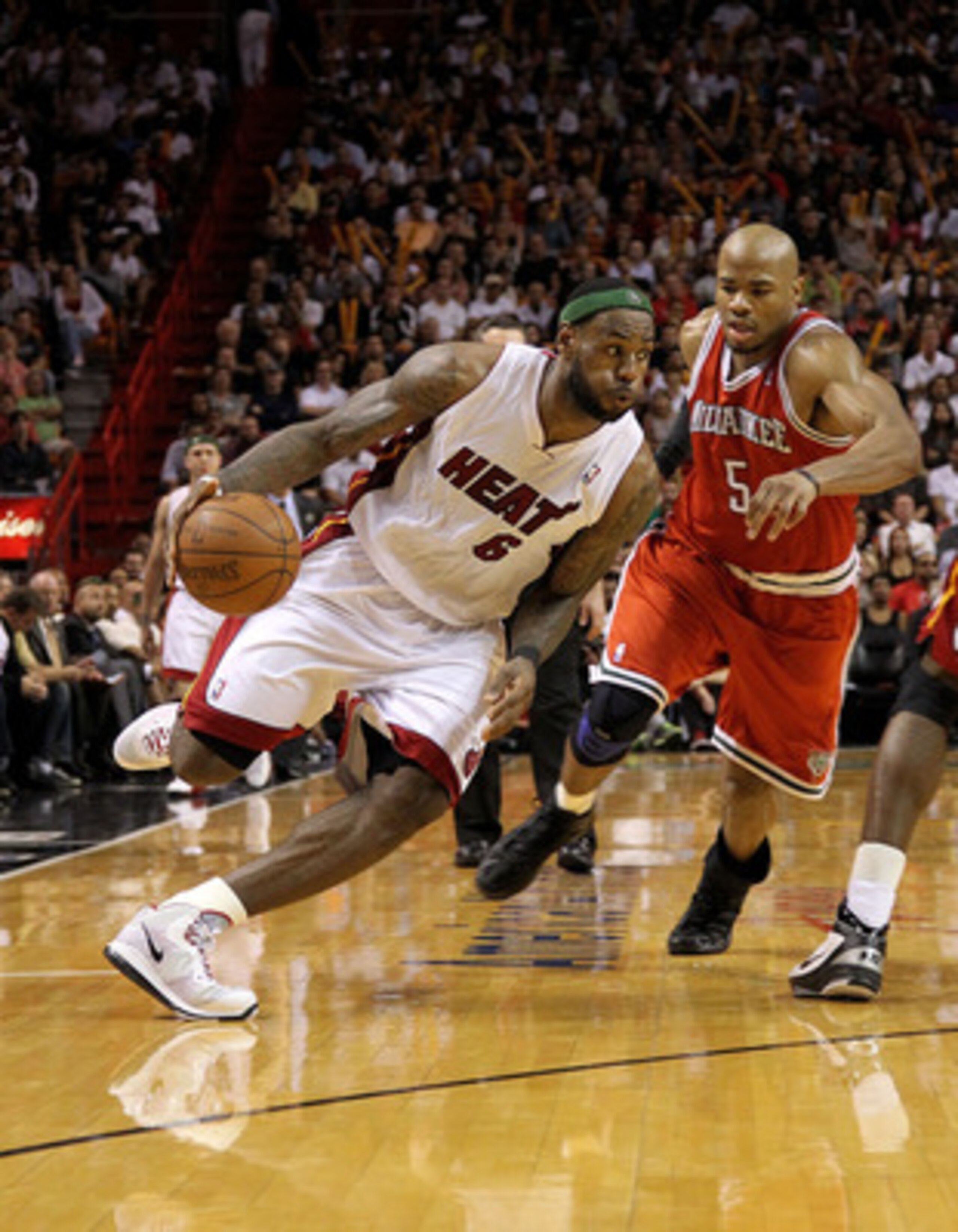 MIAMI, FL - APRIL 06:  Lebron James #6 of the Miami Heat is guarded by by Corey Maggette #5 of the Milwaukee Bucks during a game at American Airlines Arena on April 6, 2011 in Miami, Florida. NOTE TO USER: User expressly acknowledges and agrees that, by d