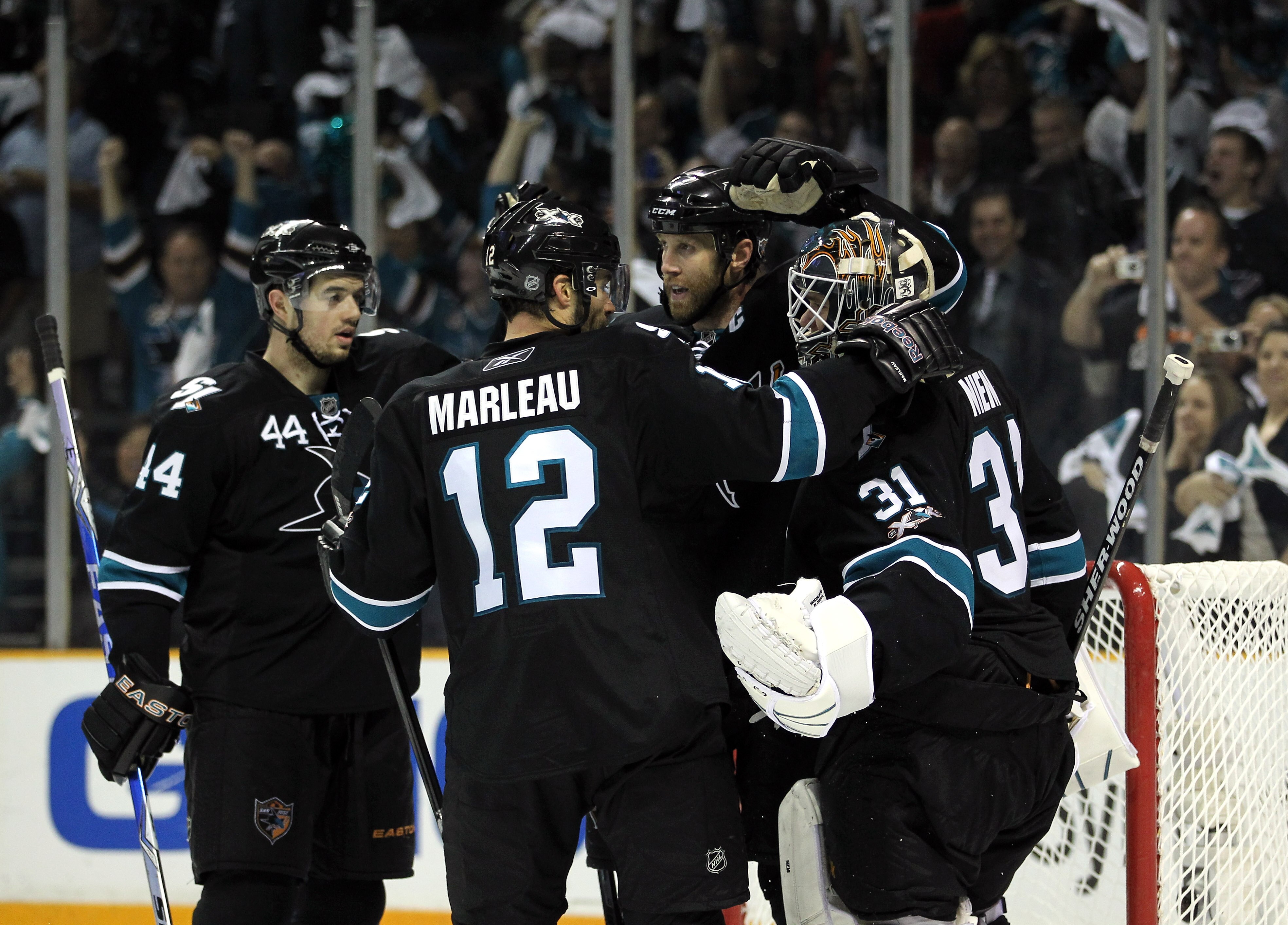 SAN JOSE, CA - MAY 01:  Joe Thornton #19, Patrick Marleau #12 and Marc-Edouard Vlasic #44 congratulates Antti Niemi #31 of the San Jose Sharks after they beat the Detroit Red Wings in Game Two of the Western Conference Semifinals during the 2011 NHL Stanl