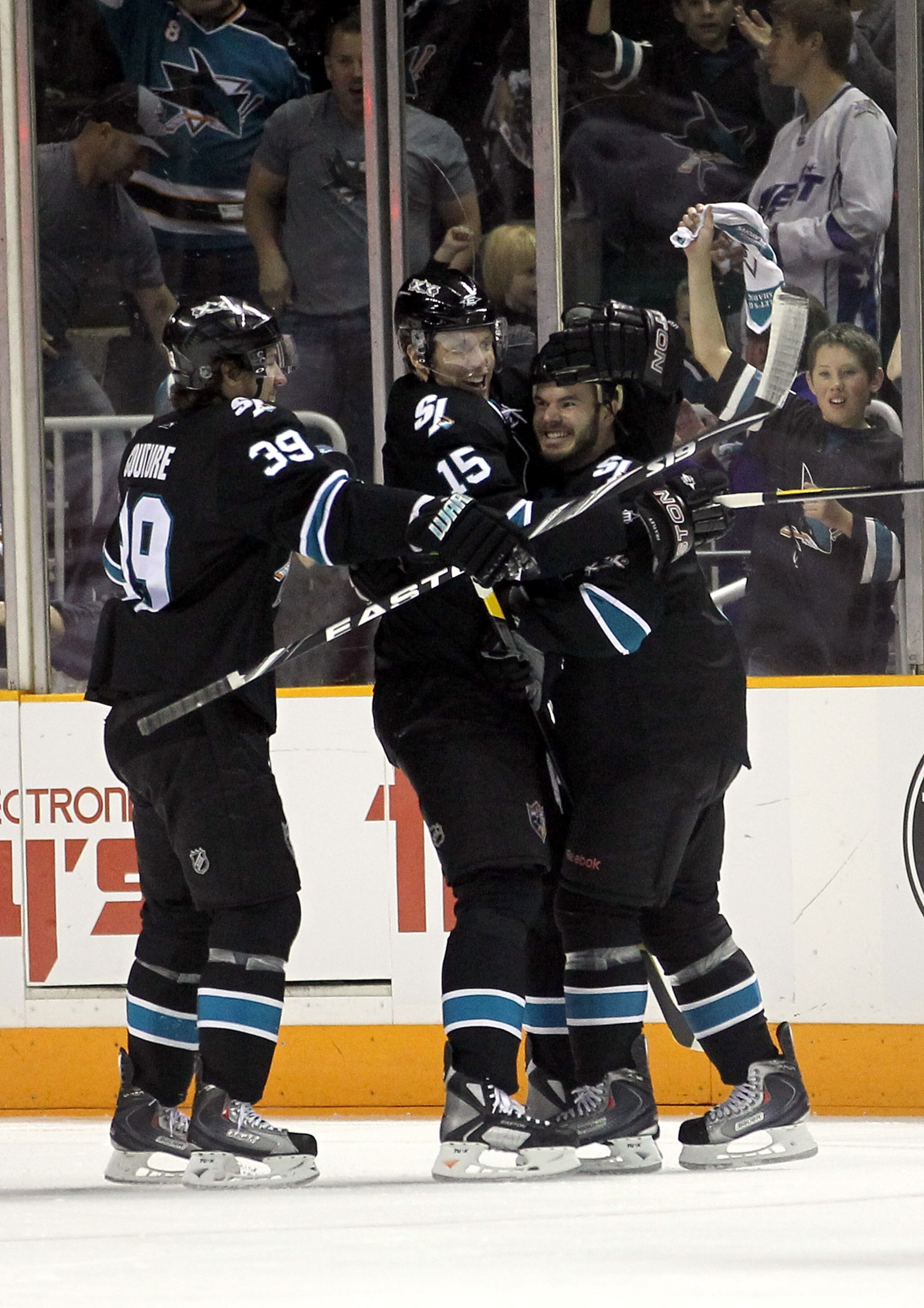 SAN JOSE, CA - MAY 01:  Ian White #9 is congratulated by Dany Heatley #15 and Logan Couture #39 of the San Jose Sharks after he scored a goal in the first period against the Detroit Red Wings in Game Two of the Western Conference Semifinals during the 201