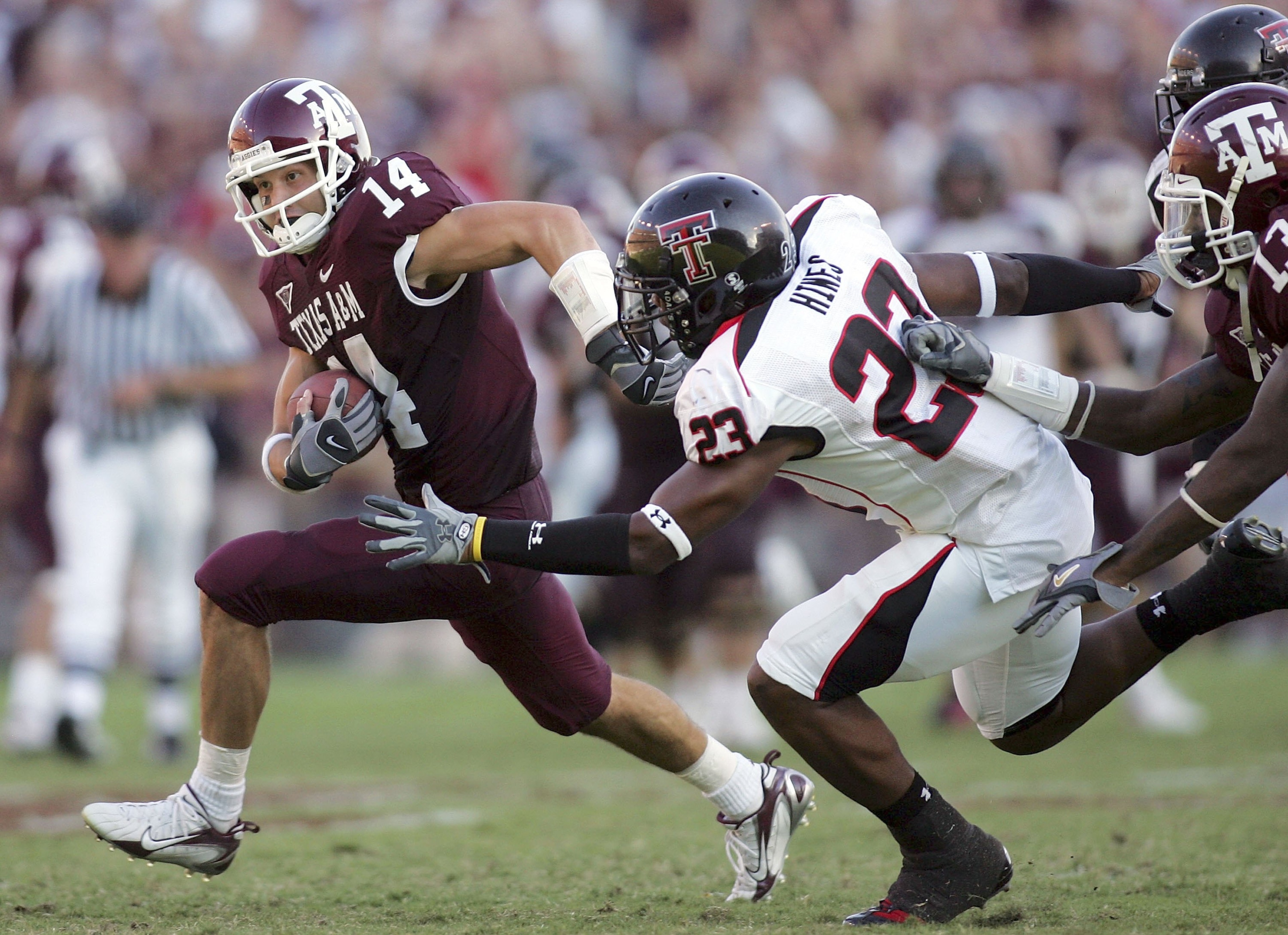 COLLEGE STATION, TX -SEPTEMBER 30:  Wide receiver Chad Schroeder #14 of the Texas A&M Aggies runs past Anthony Hines #23 of the Texas Tech Red Raiders at Kyle Field on September 30, 2006 in College Station, Texas.  (Photo by Ronald Martinez/Getty Images)