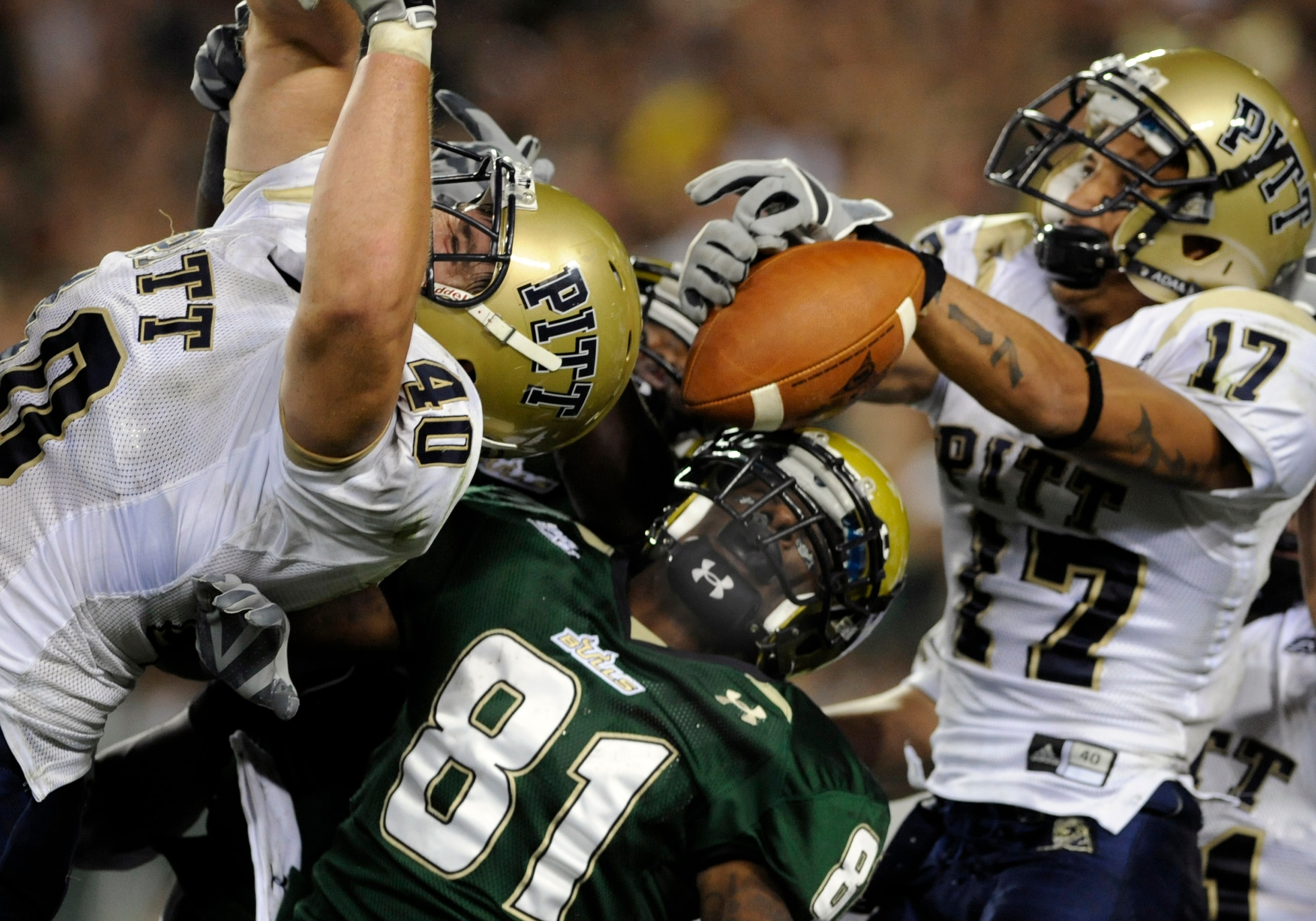TAMPA, FL - OCTOBER 2:  Linebacker Scott McKillop #40 and cornerback Aaron Berry #17 of the Pittsburgh Panthers break up a last-second, end zone pass to wire receiver Dontavia Bogan #81 of the University of South Florida Bulls at Raymond James Stadium on