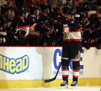 CHICAGO, IL - JANUARY 12: Fernando Pisani #15 of the Chicago Blackhawks is congratulated by teammates after scoring a goal against the Colorado Avalanche at the United Center on January 12, 2011 in Chicago, Illinois. The Blackhawks defeated the Avalanche