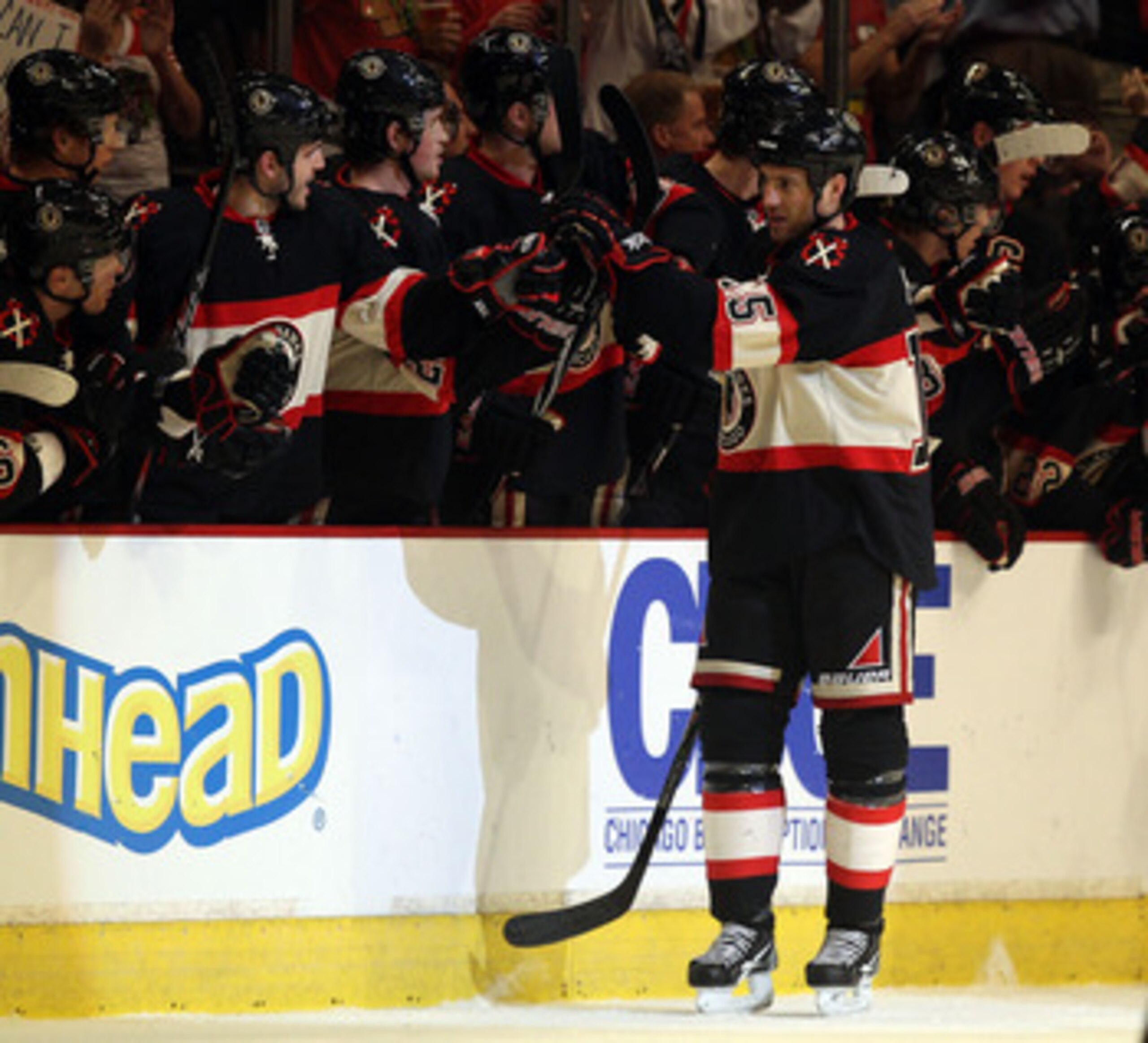 CHICAGO, IL - JANUARY 12: Fernando Pisani #15 of the Chicago Blackhawks is congratulated by teammates after scoring a goal against the Colorado Avalanche at the United Center on January 12, 2011 in Chicago, Illinois. The Blackhawks defeated the Avalanche