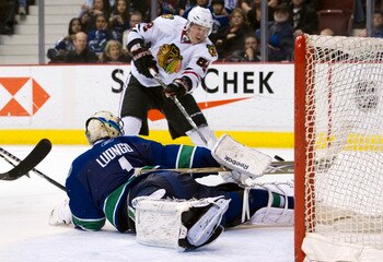 VANCOUVER, CANADA - FEBRUARY 4: Goalie Roberto Luongo #1 of the Vancouver Canucks sprawls and watches Tomas Kopecky #82 of the Chicago Blackhawks hit the post with his shot during the third period in NHL action on February 04, 2011 at Rogers Arena in Vanc