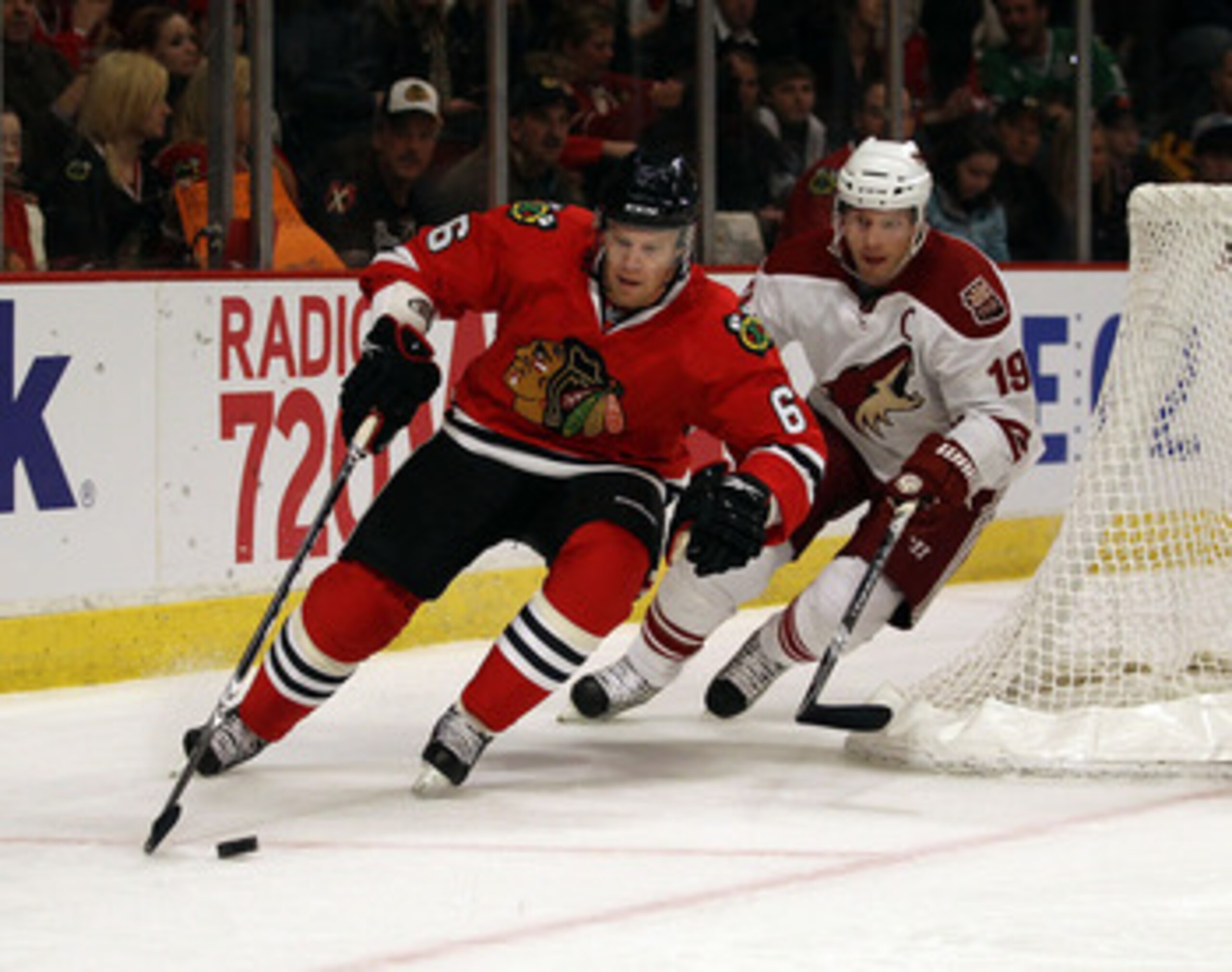 CHICAGO, IL - FEBRUARY 27: Jordan Hendry #6 of the Chicago Blackhawks controls the puck in front of Shane Doan #19 of the Phoenix Coyotes at the United Center on February 27, 2011 in Chicago, Illinois. The Blackhawks defeated the Coyotes 4-3 in a shootout