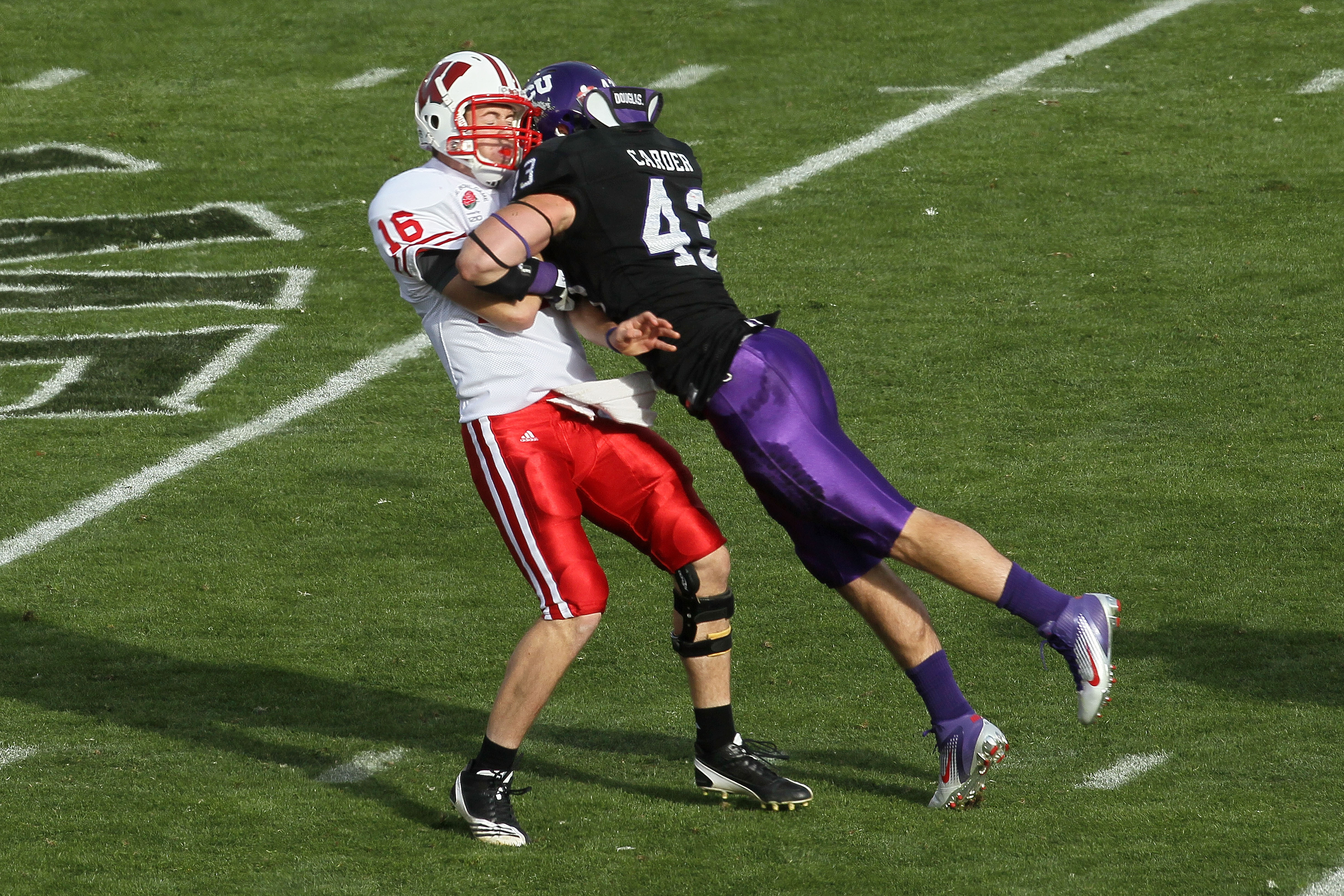PASADENA, CA - JANUARY 01: Quarterback Scott Tolzien #16 of the Wisconsin Badgers is hit by linebacker Tank Carder #43 of the TCU Horned Frogs during the 97th Rose Bowl game on January 1, 2011 in Pasadena, California. (Photo by Stephen Dunn/Getty Images PASADENA, CA - JANUARY 01: Quarterback Scott Tolzien #16 of the Wisconsin Badgers is hit by linebacker Tank Carder #43 of the TCU Horned Frogs during the 97th Rose Bowl game on January 1, 2011 in Pasadena, California. (Photo by Stephen Dunn/Getty Images