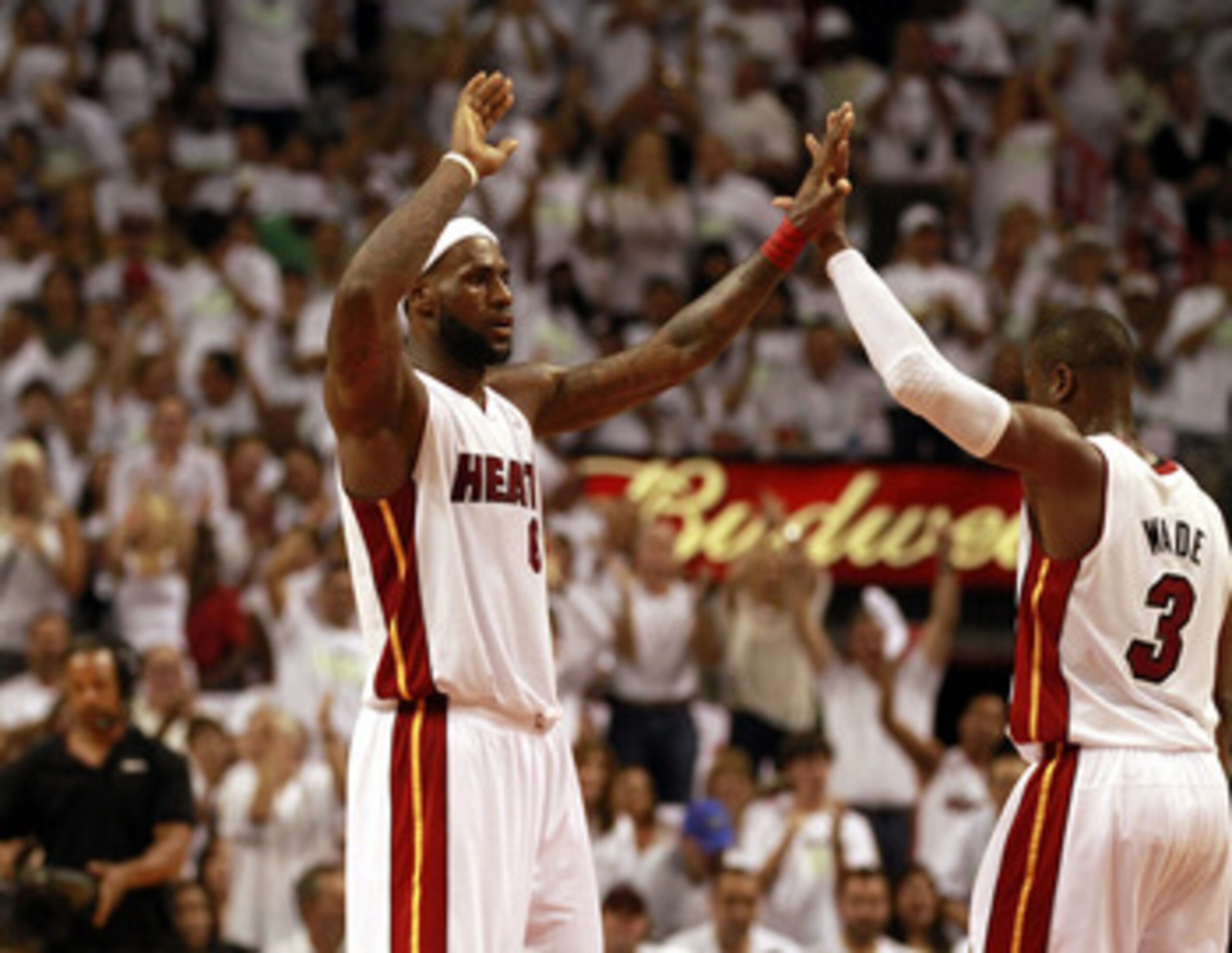 MIAMI, FL - APRIL 16:  Forward  LeBron James #6 celebrates with teammate Dwyane Wade #3 against the Philadelphia 76ers at the American Airlines Arena in Game One of the Eastern Conference Quarterfinals in the 2011 NBA Playoffs on April 16, 2011 in Miami,