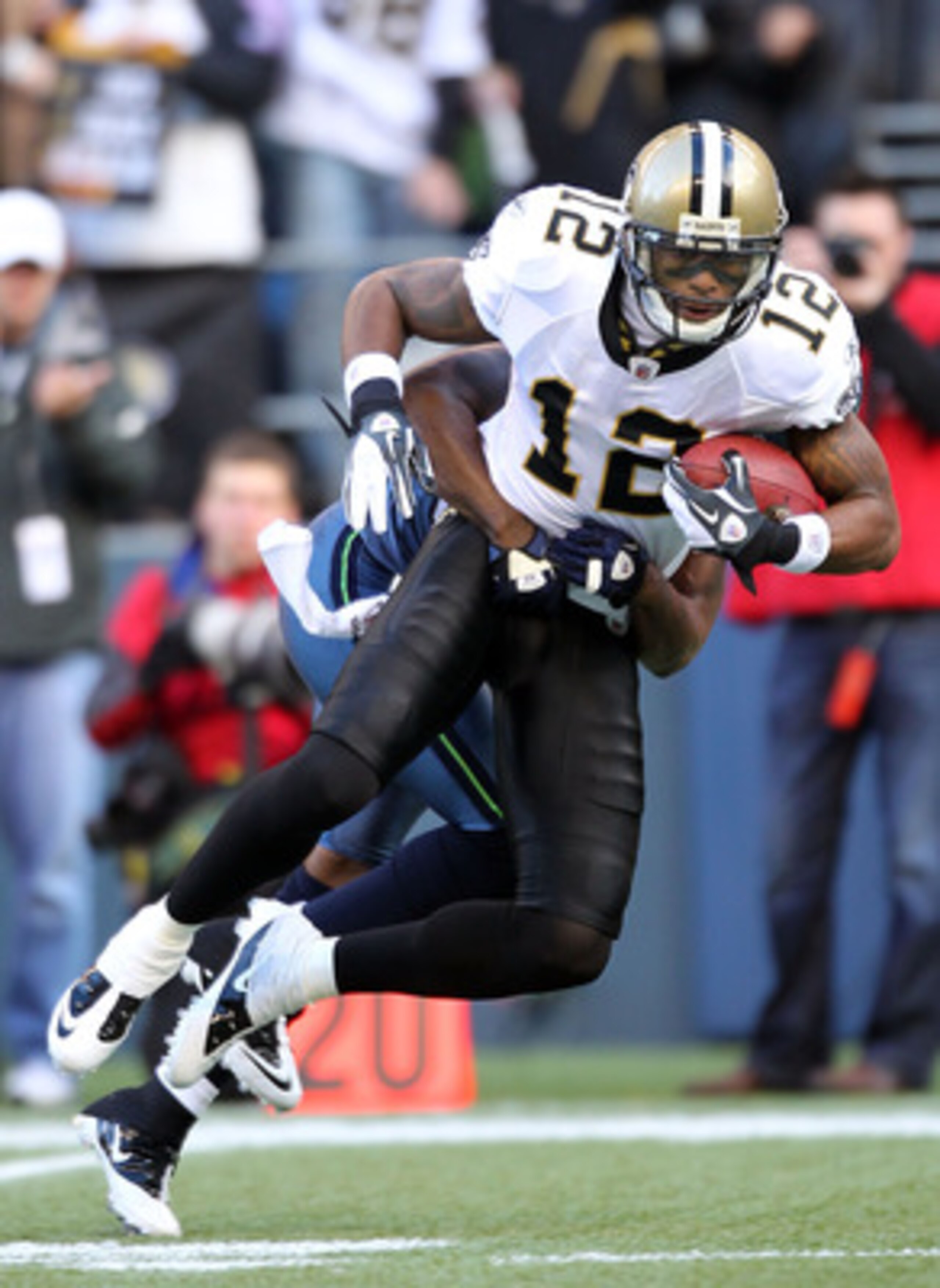 SEATTLE, WA - JANUARY 08:  Marques Colston #12 of the New Orleans Saints catches a pass in the second quarter against the Seattle Seahawks during the 2011 NFC wild-card playoff game at Qwest Field on January 8, 2011 in Seattle, Washington.  (Photo by Otto