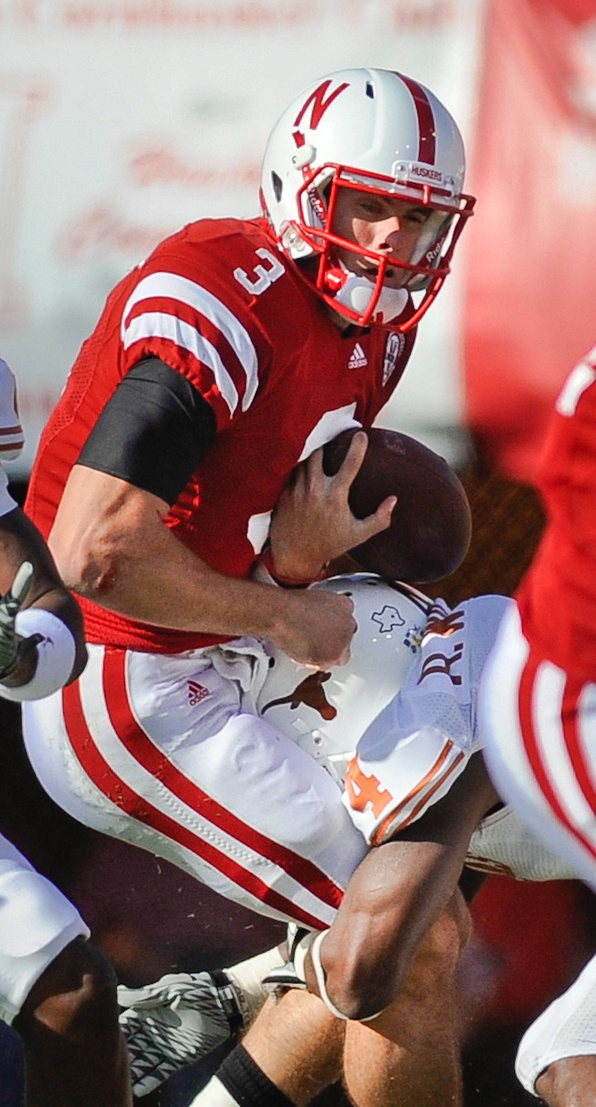 LINCOLN, NE - OCTOBER 16: Quarterback Taylor Martinez #3 of the Nebraska Cornhuskers gets the ball knocked loose by cornerback Aaron Williams #4 of the Texas Longhorns during their game at Memorial Stadium on October 16, 2010 in Lincoln, Nebraska. Texas D LINCOLN, NE - OCTOBER 16: Quarterback Taylor Martinez #3 of the Nebraska Cornhuskers gets the ball knocked loose by cornerback Aaron Williams #4 of the Texas Longhorns during their game at Memorial Stadium on October 16, 2010 in Lincoln, Nebraska. Texas D