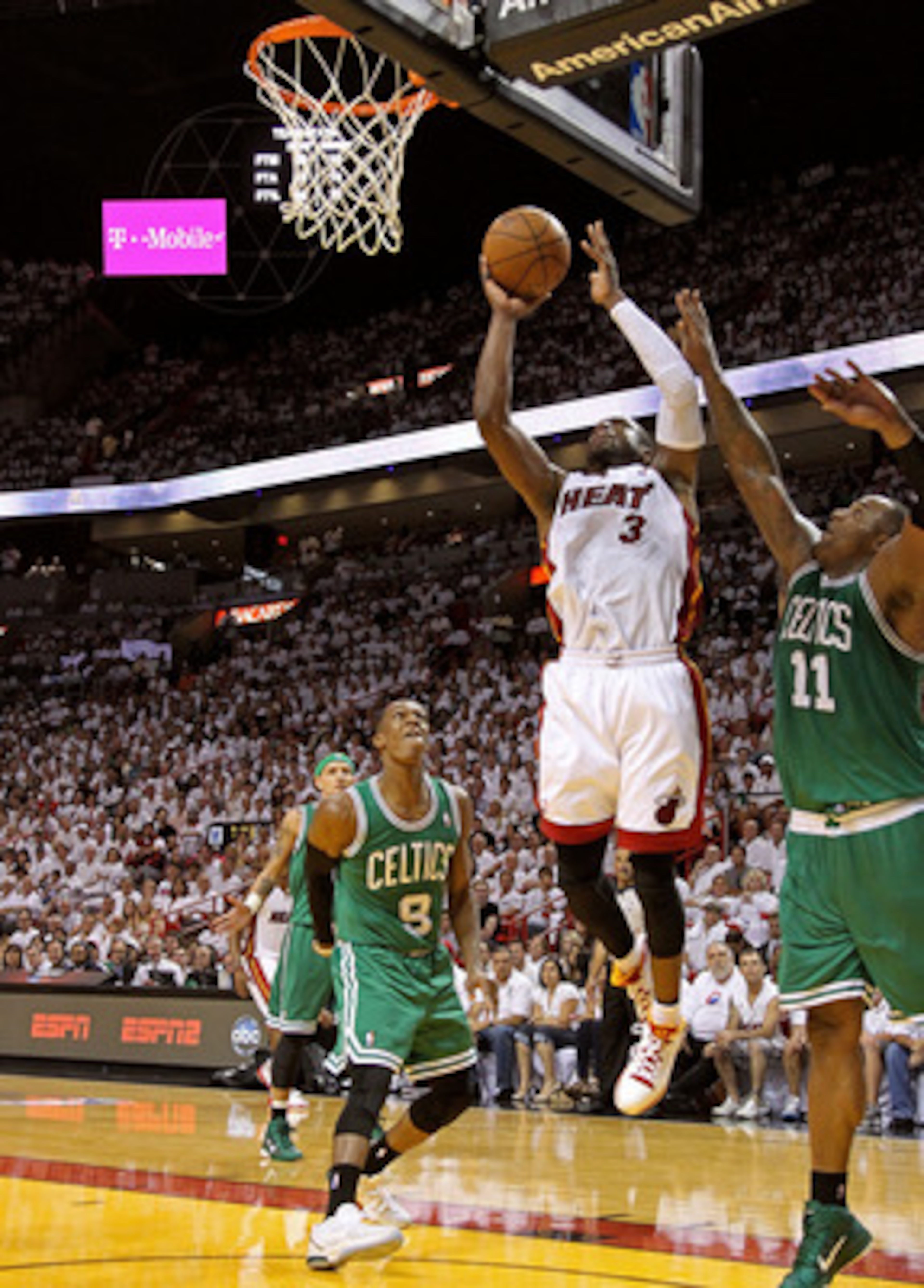 MIAMI, FL - MAY 01:  Dwyane Wade #3 of the Miami Heat shoots over Rajon Rondo #9 of the Boston Celtics during Game One of the Eastern Conference Semifinals of the 2011 NBA Playoffs at American Airlines Arena on May 1, 2011 in Miami, Florida. NOTE TO USER: