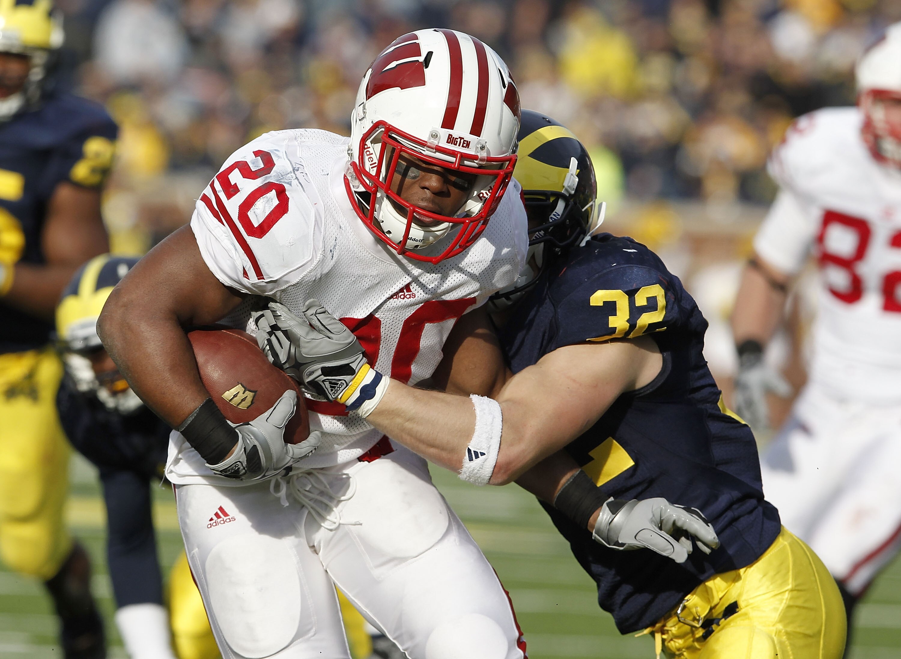 ANN ARBOR, MI - NOVEMBER 20: James White #20 of the Wisconsin Badgers treies to get around the tackle of Jordan Kovacs #32 of the Michigan Wolverines at Michigan Stadium on November 20, 2010 in Ann Arbor, Michigan. Wisconson won the game 48-28. (Photo b ANN ARBOR, MI - NOVEMBER 20: James White #20 of the Wisconsin Badgers treies to get around the tackle of Jordan Kovacs #32 of the Michigan Wolverines at Michigan Stadium on November 20, 2010 in Ann Arbor, Michigan. Wisconson won the game 48-28. (Photo b