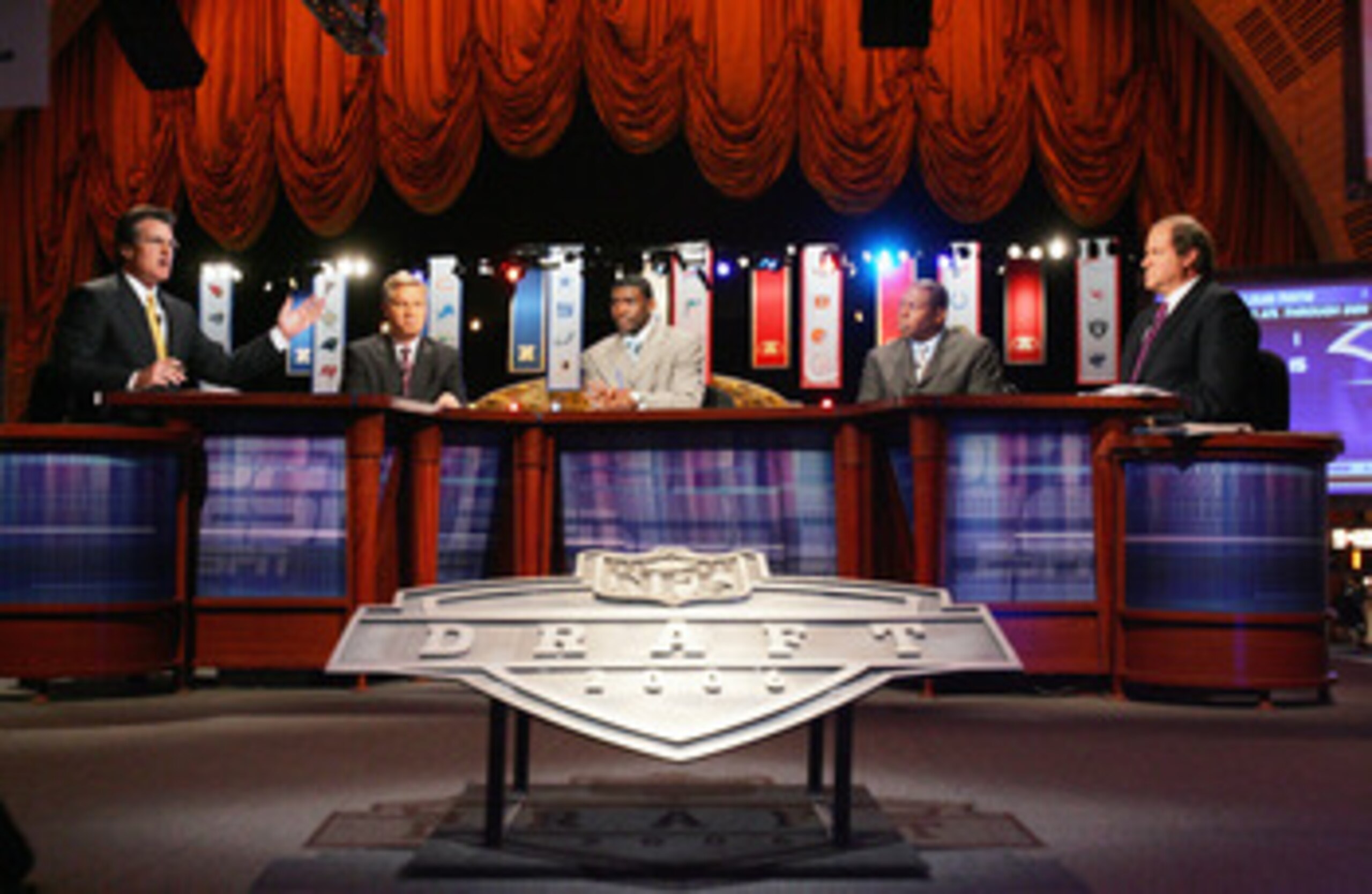 NEW YORK - APRIL 29:  (L-R) Mel Kiper, Chris Mortensen, Michael Irvin, Tom Jackson and Chris Berman of ESPN broadcast their coverage during the 2006 NFL Draft on April 29, 2006 at Radio City Music Hall in New York, New York. (Photo by Chris Trotman/Getty 