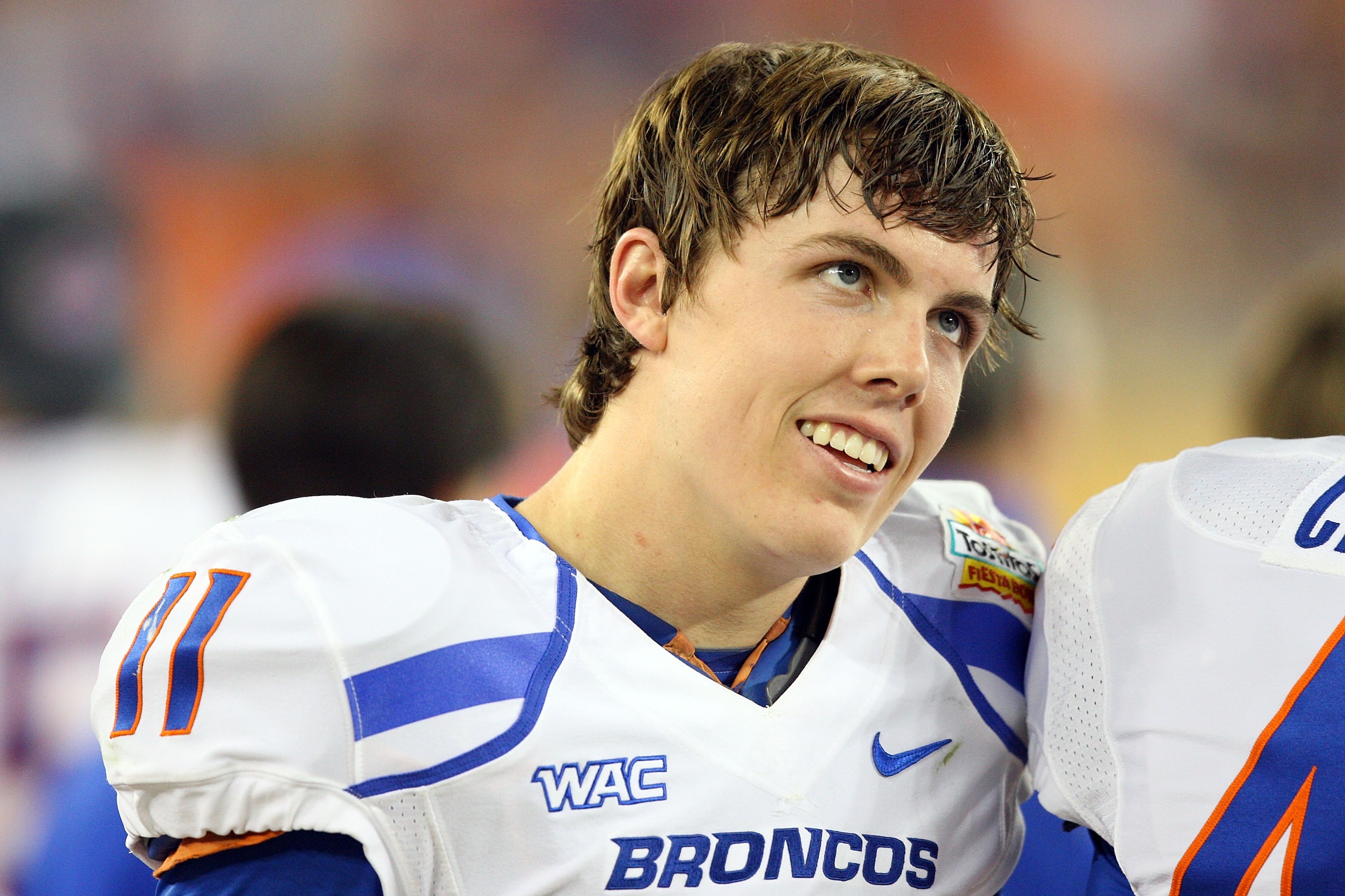 GLENDALE, AZ - JANUARY 04:  Quarterback Kellen Moore #11 of the Boise State Broncos smiles on the sideline in the second half against the TCU Horned Frogs during the Tostitos Fiesta Bowl at the Universtity of Phoenix Stadium on January 4, 2010 in Glendale
