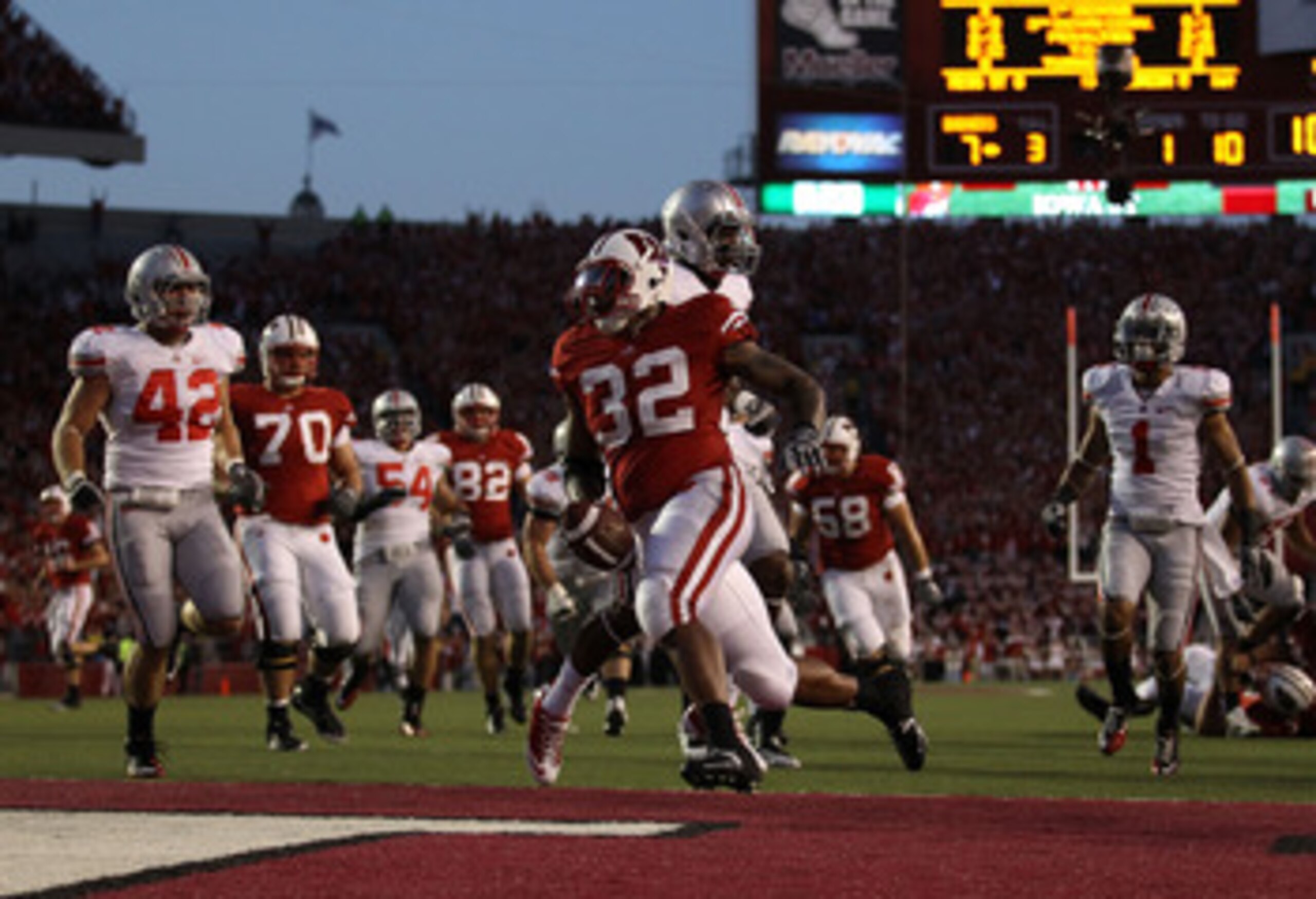 MADISON, WI - OCTOBER 16: John Clay #32 of the Wisconsin Badgers scores a touchdown against the Ohio State Buckeyes at Camp Randall Stadium on October 16, 2010 in Madison, Wisconsin. Wisconsin defeated Ohio State 31-18. (Photo by Jonathan Daniel/Getty Ima MADISON, WI - OCTOBER 16: John Clay #32 of the Wisconsin Badgers scores a touchdown against the Ohio State Buckeyes at Camp Randall Stadium on October 16, 2010 in Madison, Wisconsin. Wisconsin defeated Ohio State 31-18. (Photo by Jonathan Daniel/Getty Ima