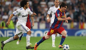 MADRID, SPAIN - APRIL 27:  Lionel Messi of Barcelona beats Marcelo of Real Madrid during the UEFA Champions League Semi Final first leg match between Real Madrid and Barcelona at Estadio Santiago Bernabeu on April 27, 2011 in Madrid, Spain.  (Photo by Ale