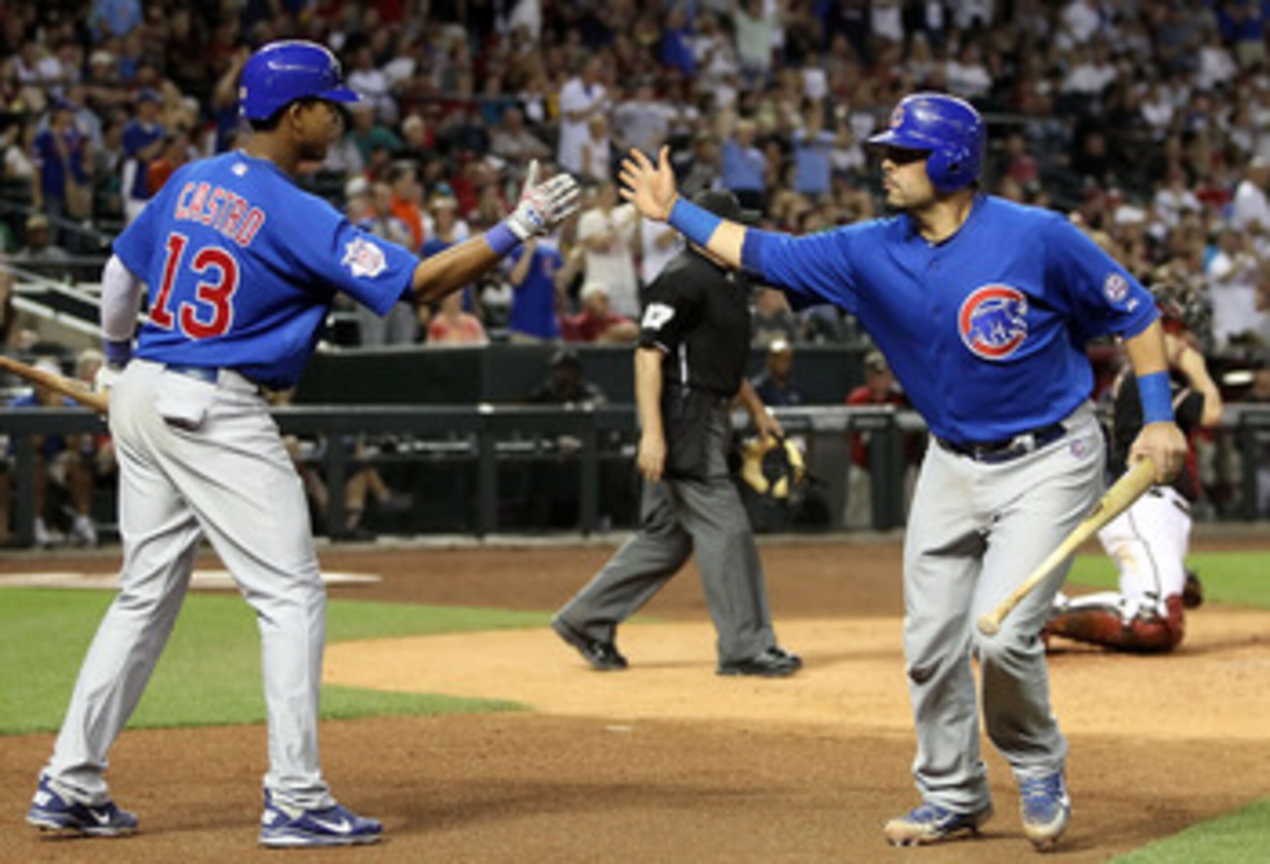 PHOENIX, AZ - APRIL 30:  Geovany Soto #18 of the Chicago Cubs high fives teammate Starlin Castro #13 after scoring against the Arizona Diamondbacks during the ninth inning of the Major League Baseball game at Chase Field on April 30, 2011 in Phoenix, Ariz