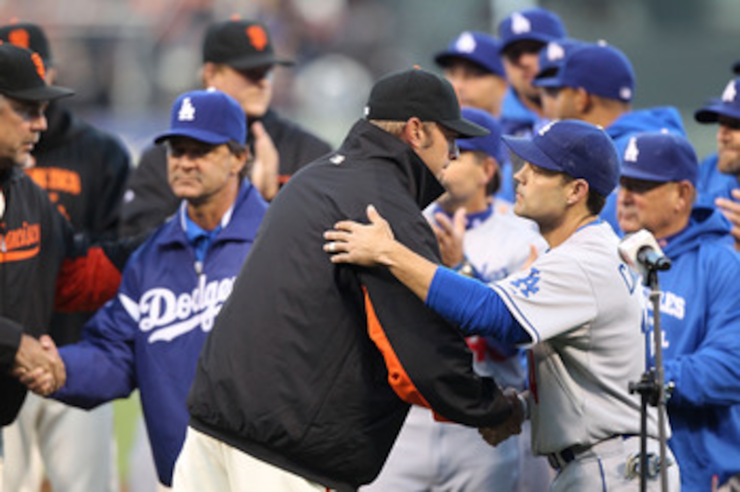 SAN FRANCISCO, CA - APRIL 11:  Jeremy Affeldt # 41 of the San Francisco Giants shakes hands with Jamey Carroll #14 of the Los Angeles Dodgers after speaking about Brian Stow, the Giants fan who was attacked last week at a Dodgers game in Los Angeles, befo