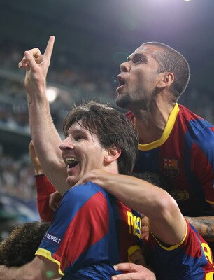 MADRID, SPAIN - APRIL 27:  Lionel Messi of Barcelona celebrates with Dani Alves after scoring his second goal during the UEFA Champions League Semi Final first leg match between Real Madrid and Barcelona at Estadio Santiago Bernabeu on April 27, 2011 in M