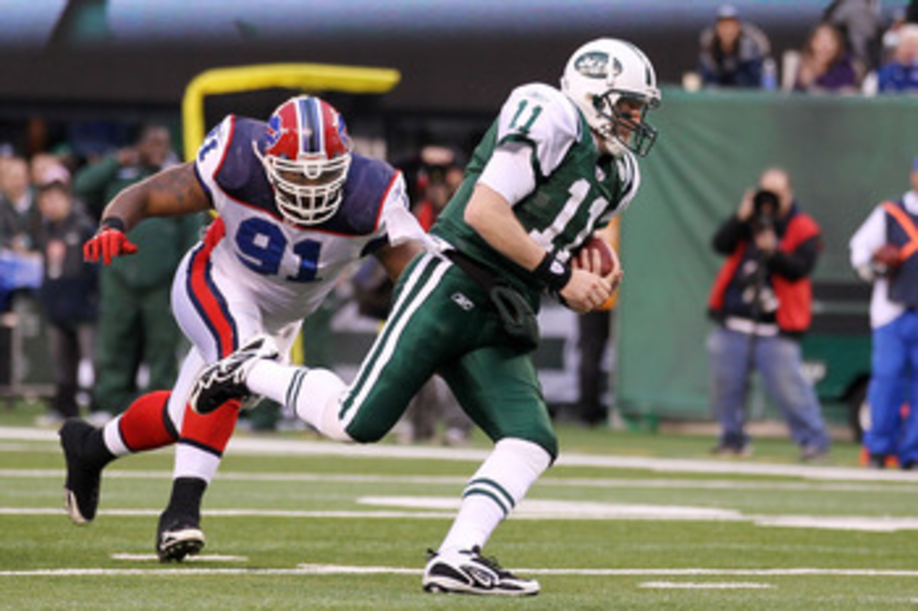 EAST RUTHERFORD, NJ - JANUARY 02: Kellen Clemens #11 of the New York Jets carries the ball against Spencer Johnson #91 of the Buffalo Bills at New Meadowlands Stadium on January 2, 2011 in East Rutherford, New Jersey. (Photo by Al Bello/Getty Images)