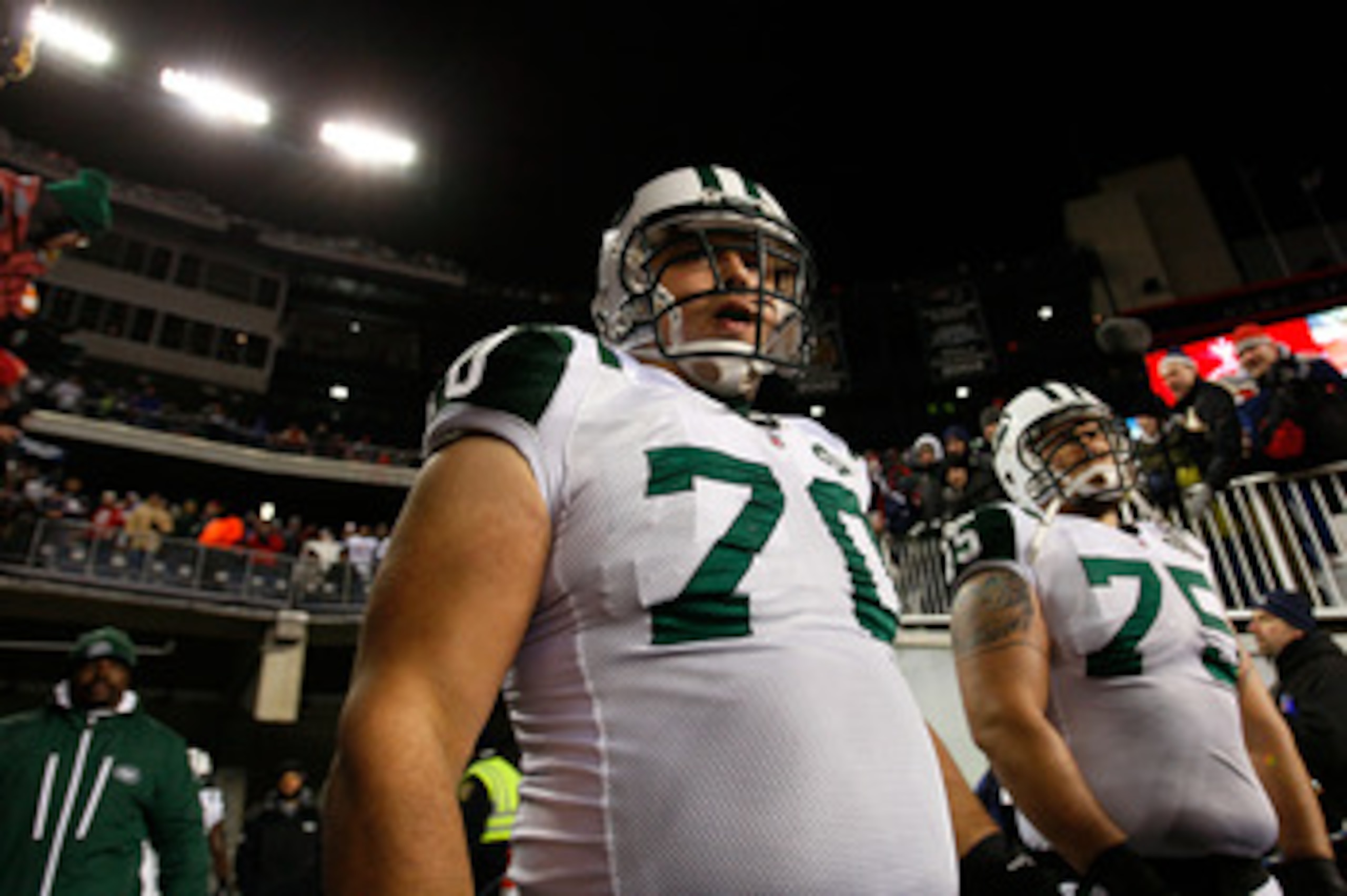 FOXBORO, MA - DECEMBER 06:  (L-R) Mike DeVito #70 and Robert Turner #75 of the New York Jets wait to take the field against the New England Patriots at Gillette Stadium on December 6, 2010 in Foxboro, Massachusetts.  (Photo by Jim Rogash/Getty Images)