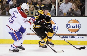 BOSTON, MA - MARCH 24:  Brad Marchand #63 of the Boston Bruins heads for the net as Brent Sopel #55 of the Montreal Canadiens defends on March 24, 2011 at the TD Garden in Boston, Massachusetts.  The Boston Bruins defeated the Montreal Canadiens 7-0.  (Ph