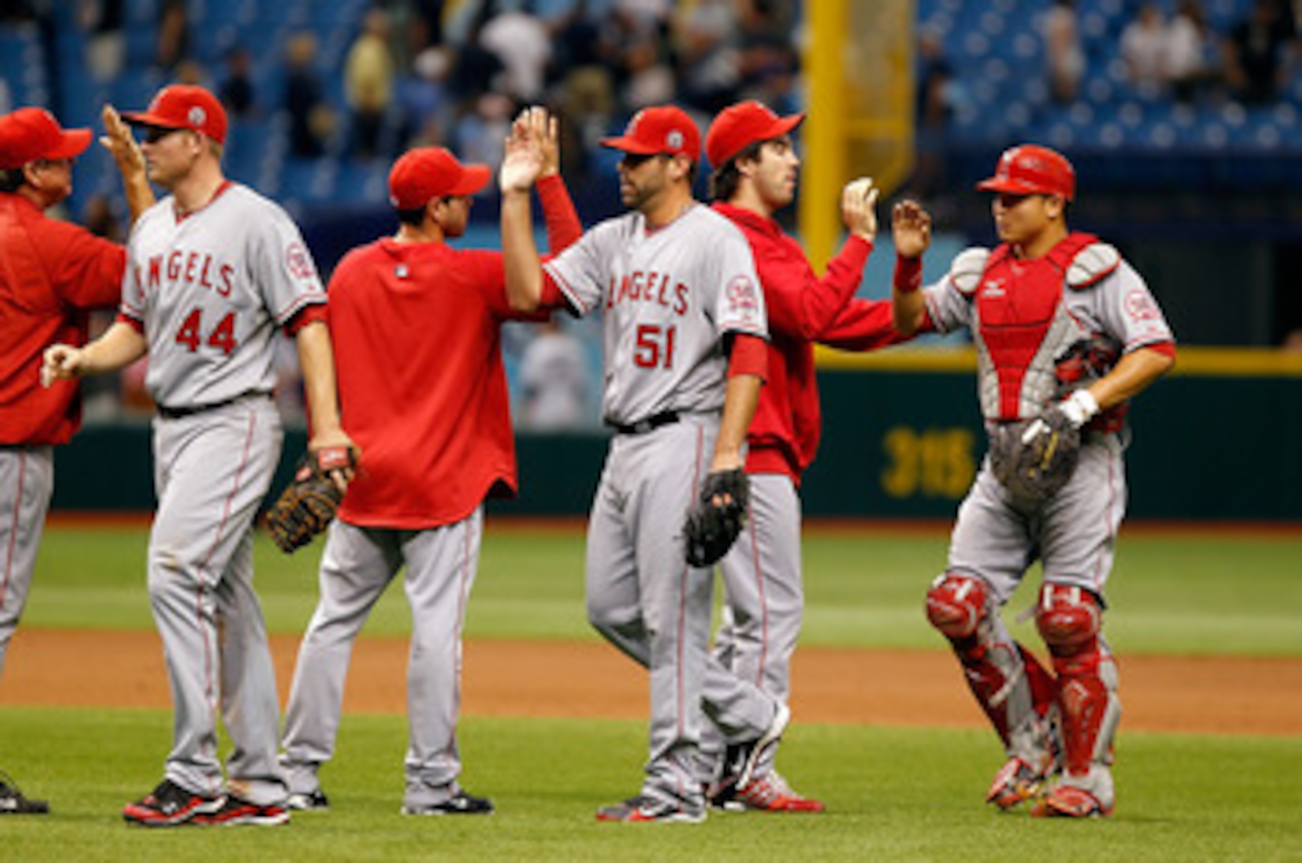 ST. PETERSBURG, FL - MAY 01:  Pitcher Jordan Walden #51 of the Los Angeles Angels of Anaheim is congratulated by his teammates after their victory over the Tampa Bay Rays during the game at Tropicana Field on May 1, 2011 in St. Petersburg, Florida.  (Phot