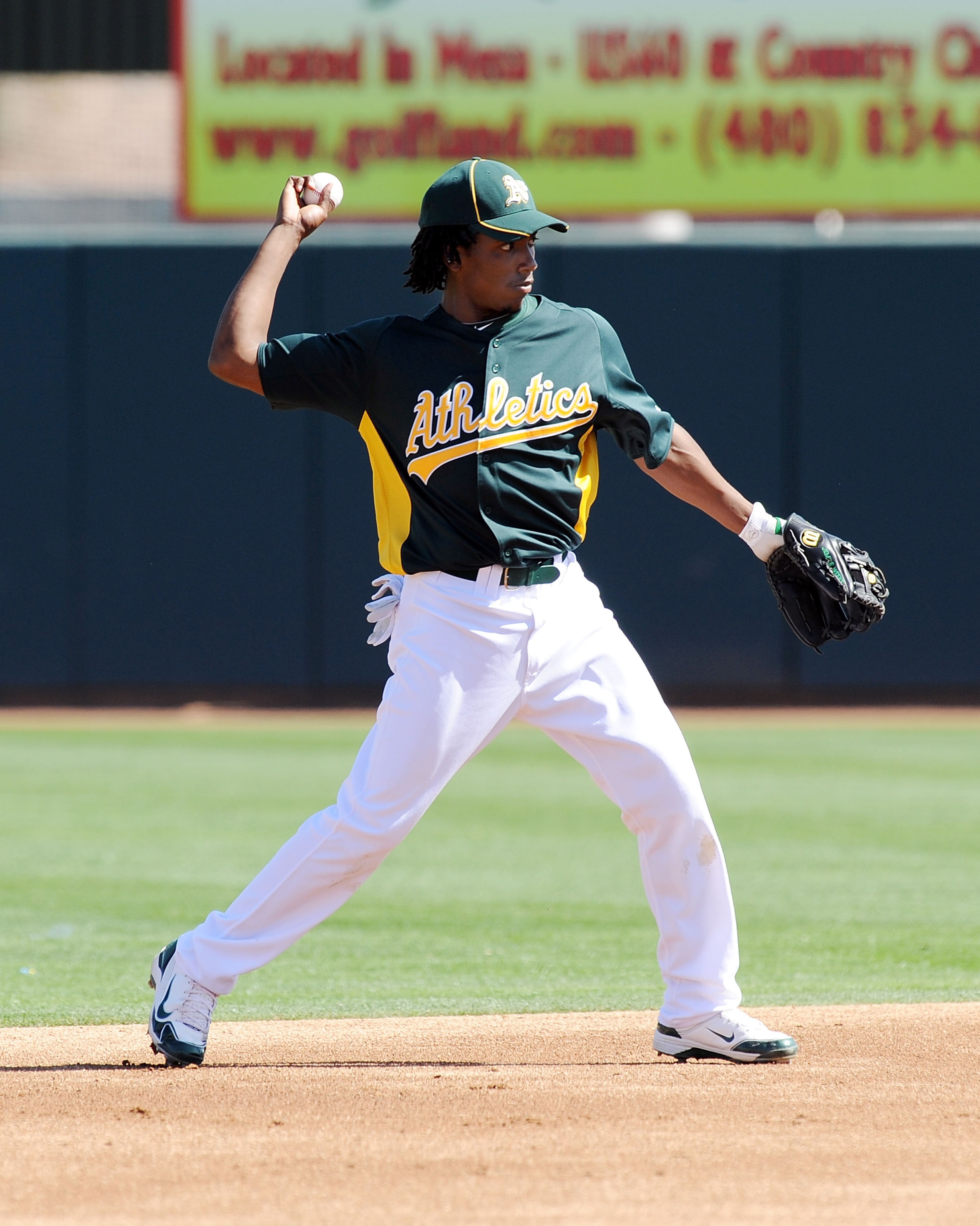 PHOENIX, AZ - MARCH 04:  Jemile Weeks #59 of the Oakland Athletics throws the ball to first base against the Texas Rangers at Phoenix Municipal Stadium on March 4, 2011 in Phoenix, Arizona.  (Photo by Norm Hall/Getty Images)