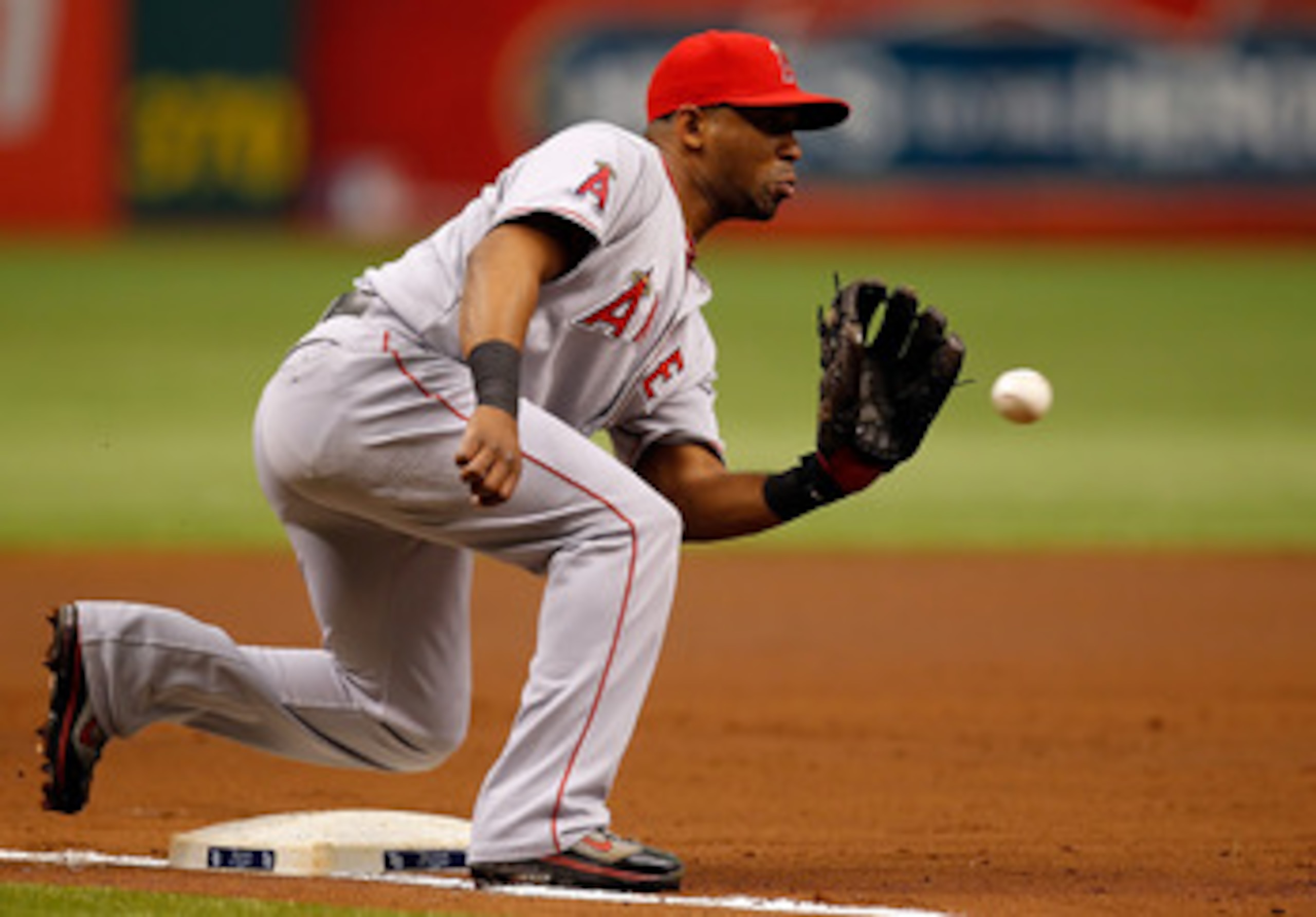ST. PETERSBURG, FL - MAY 01:  Infielder Alberto Callaspo #6 of the Los Angeles Angels of Anaheim takes the throw at third against the Tampa Bay Rays during the game at Tropicana Field on May 1, 2011 in St. Petersburg, Florida.  (Photo by J. Meric/Getty Im