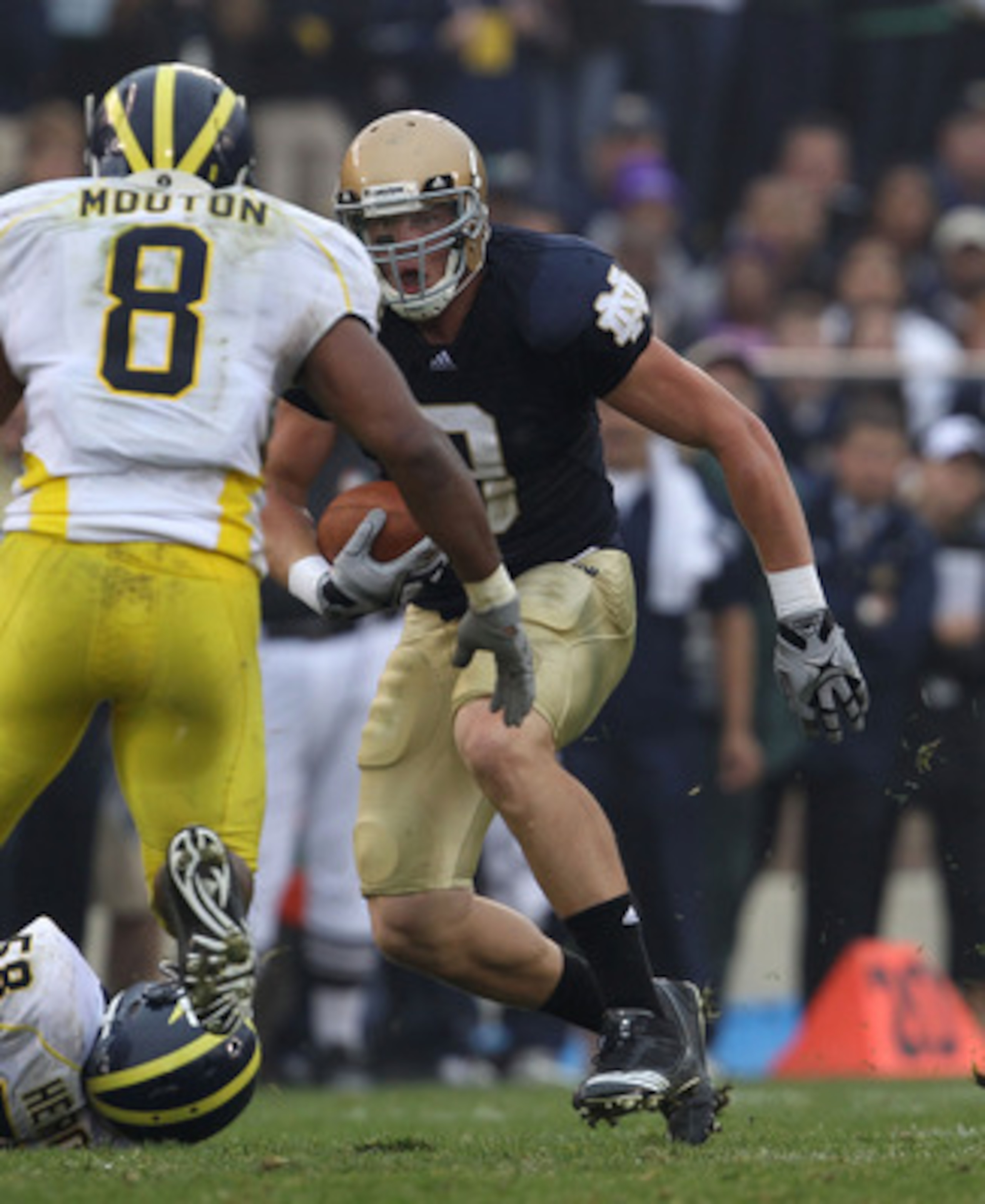 SOUTH BEND, IN - SEPTEMBER 11: Kyle Randolph #9 of the Notre Dame Fighting Irish runs as Jonas Mouton #8 of the Michigan Wolverines closes in at Notre Dame Stadium on September 11, 2010 in South Bend, Indiana. Michigan defeated Notre Dame 28-24.  (Photo b