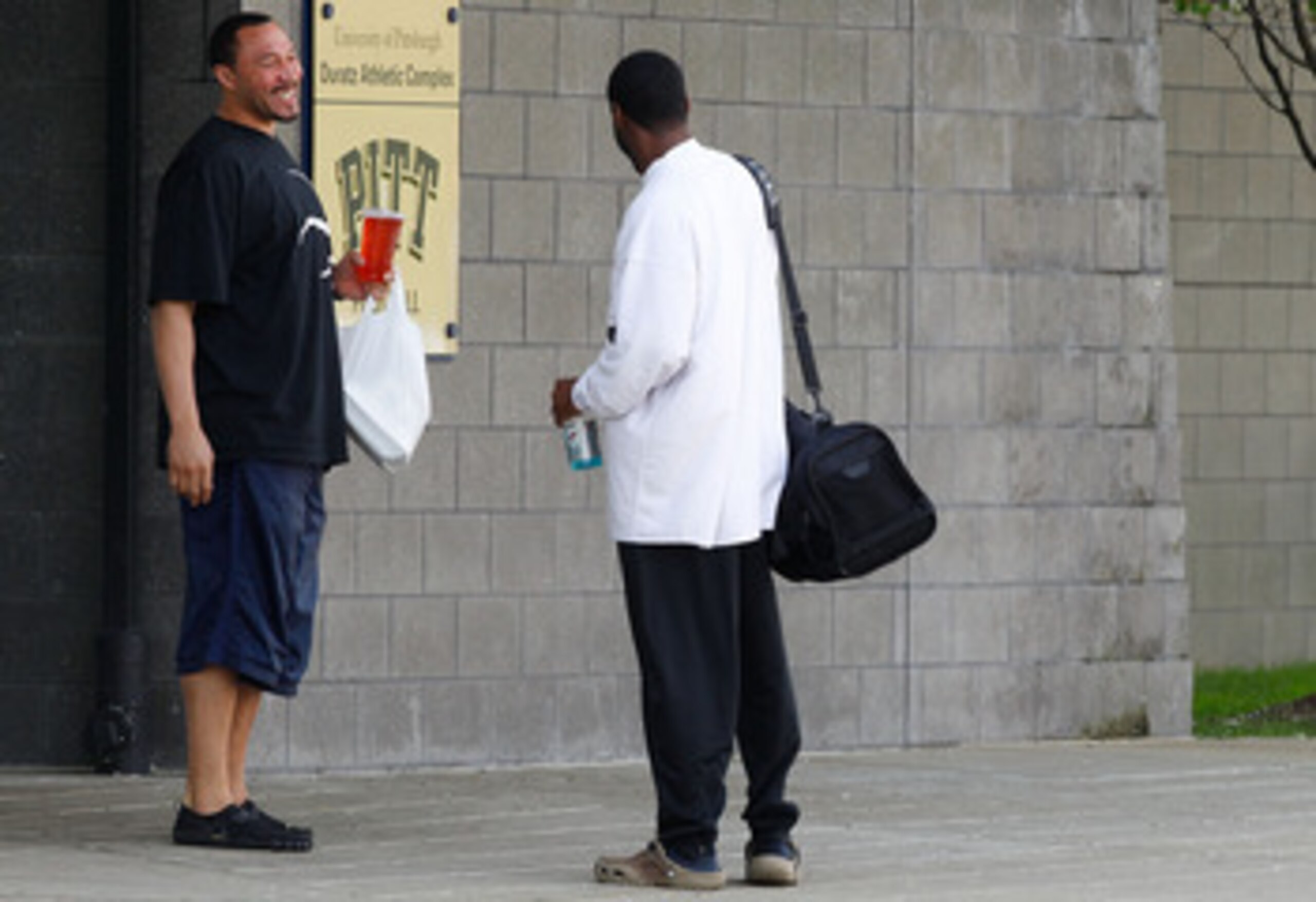 PITTSBURGH - APRIL 26:  A day after the NFL lockout was lifted, Charlie Batch #16 of the Pittsburgh Steelers shares a laugh with a University of Pittsburgh employee before leaving the South Side training facility on April 26, 2011 in Pittsburgh, Pennsylva