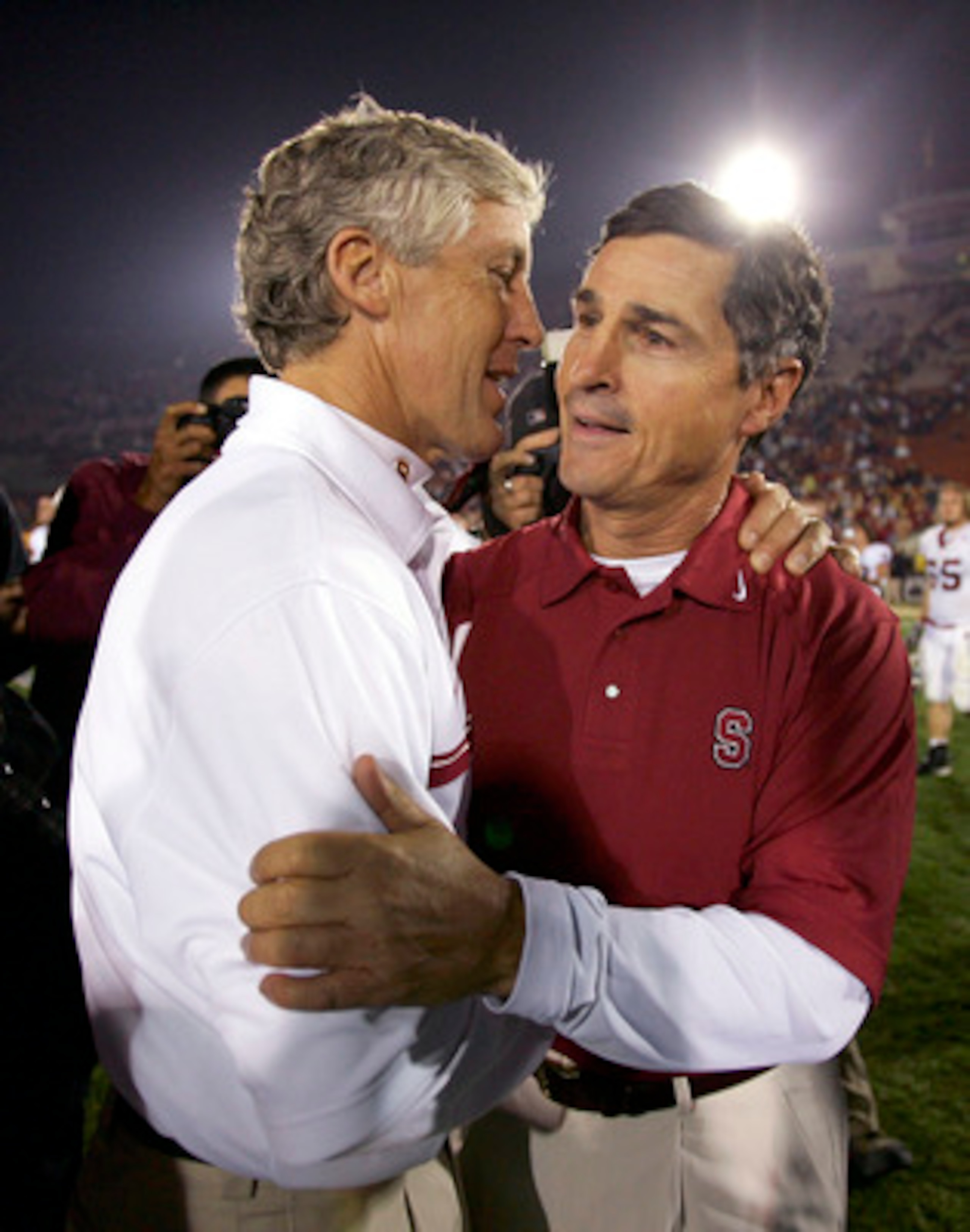 LOS ANGELES - NOVEMBER 5:  Head coach Pete Carroll (L) of the USC Trojans and head coach Walt Harris of the Stanford Cardinal congratulate each other following their game at the Los Angeles Memorial Coliseum on November 5, 2005 in Los Angeles, California.