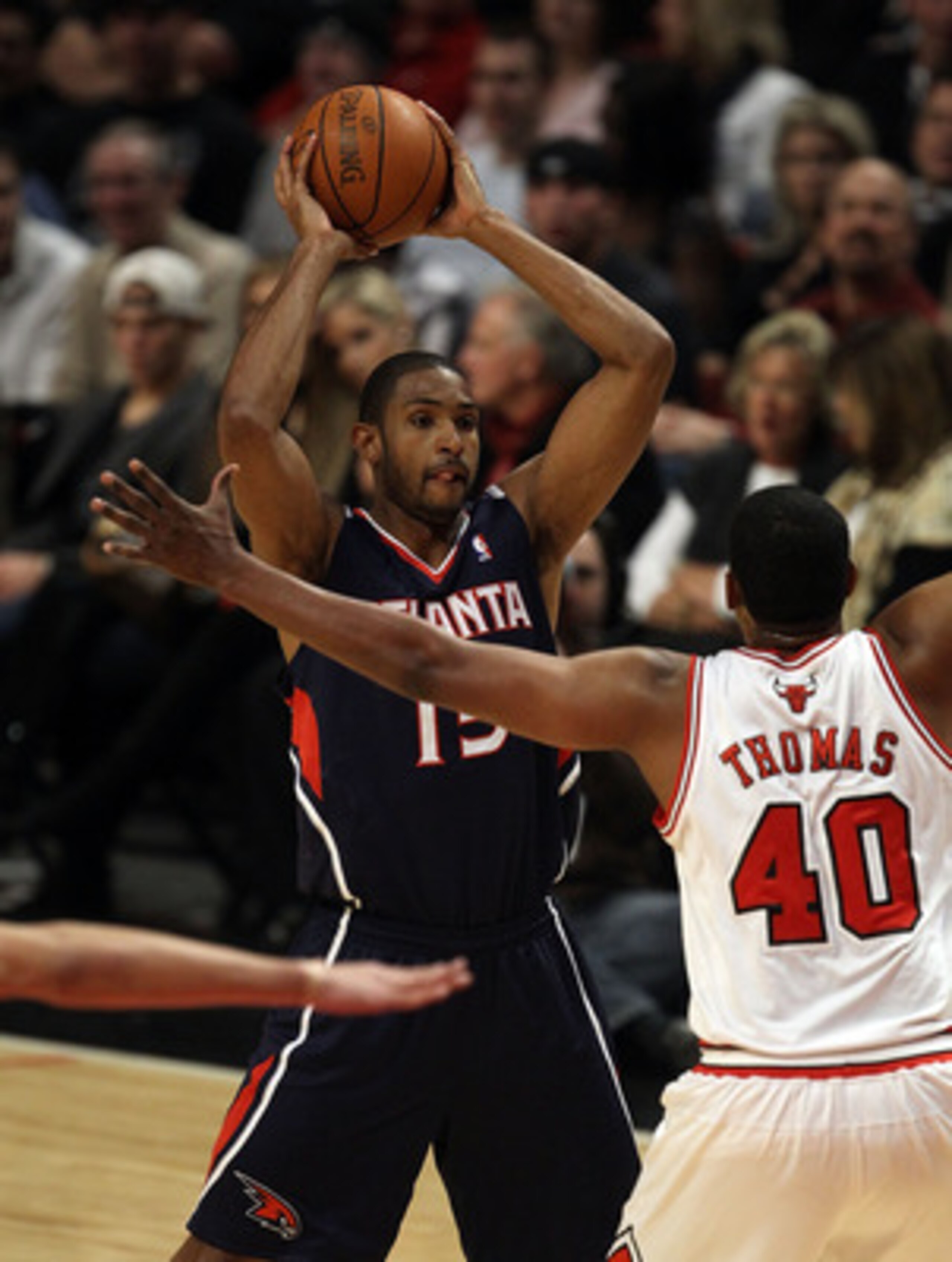 CHICAGO, IL - MARCH 11: Al Horford #15 of the Atlanta Hawks looks to pass against Kurt Thomas #40 of the Chicago Bulls at the United Center on March 11, 2011 in Chicago, Illinois. The Bulls defeated the Hawks 94-76. NOTE TO USER: User expressly acknowledg