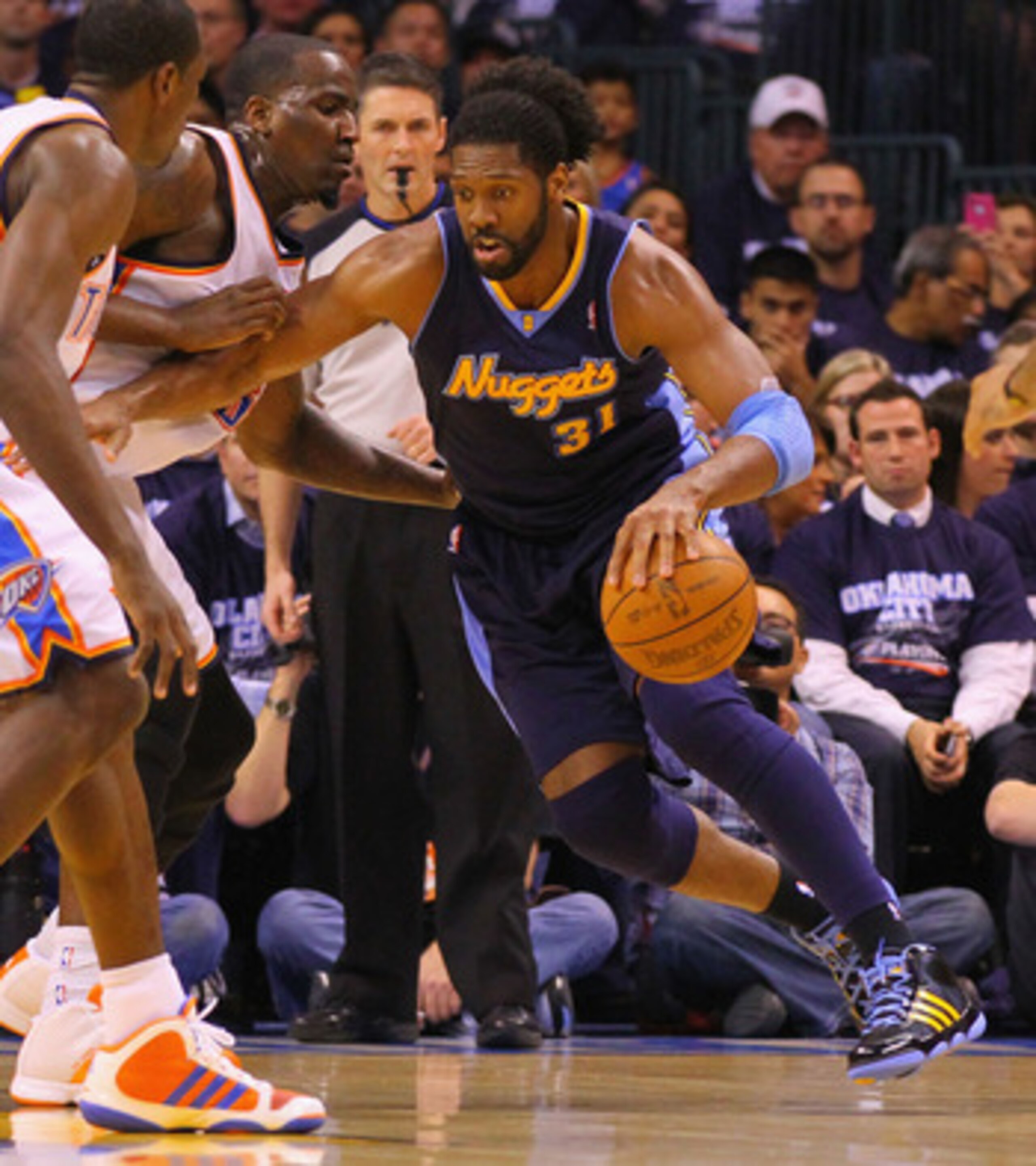 OKLAHOMA CITY, OK - APRIL 27: Nene Hilario #31 of the Denver Nuggets drives to the basket against Kendrick Perkins #5 of the Oklahoma City Thunder in Game Five of the Western Conference Quarterfinals in the 2011 NBA Playoffs on April 27, 2011 at the Ford