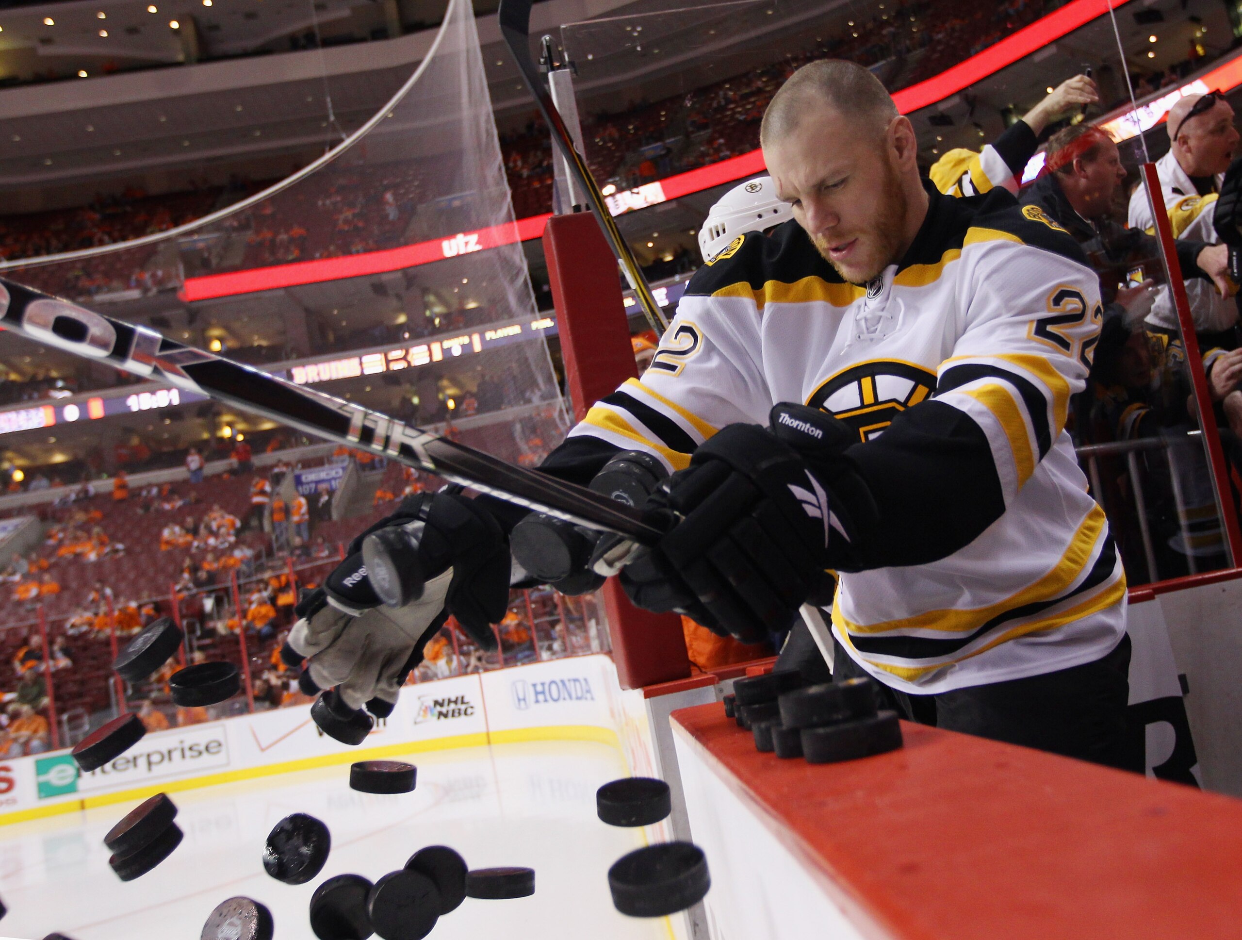PHILADELPHIA, PA - APRIL 30: Shawn Thornton #22 of the Boston Bruins tosses pucks onto the ice prior to playing against the Philadelphia Flyers  in Game One of the Eastern Conference Semifinals during the 2011 NHL Stanley Cup Playoffs at the Wells Fargo C