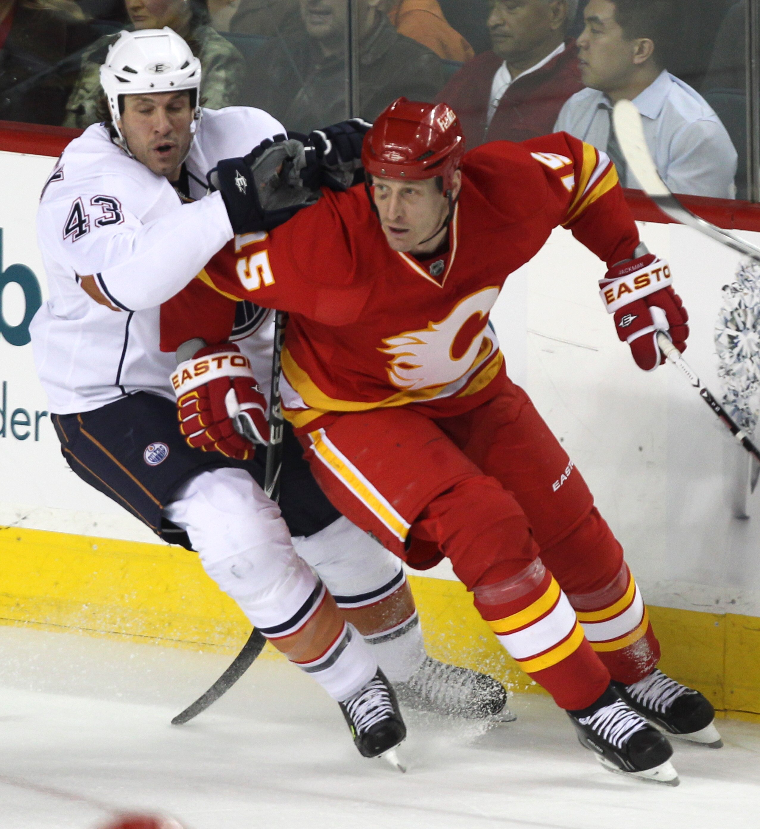 CALGARY, CANADA - APRIL 6: Tim Jackman #15 of the Calgary Flames tries to get around Jason Strudwick #43 of the Edmonton Oilers in first period NHL action on April 6, 2011 at the Scotiabank Saddledome in Calgary, Alberta, Canada. (Photo by Mike Ridewood/G