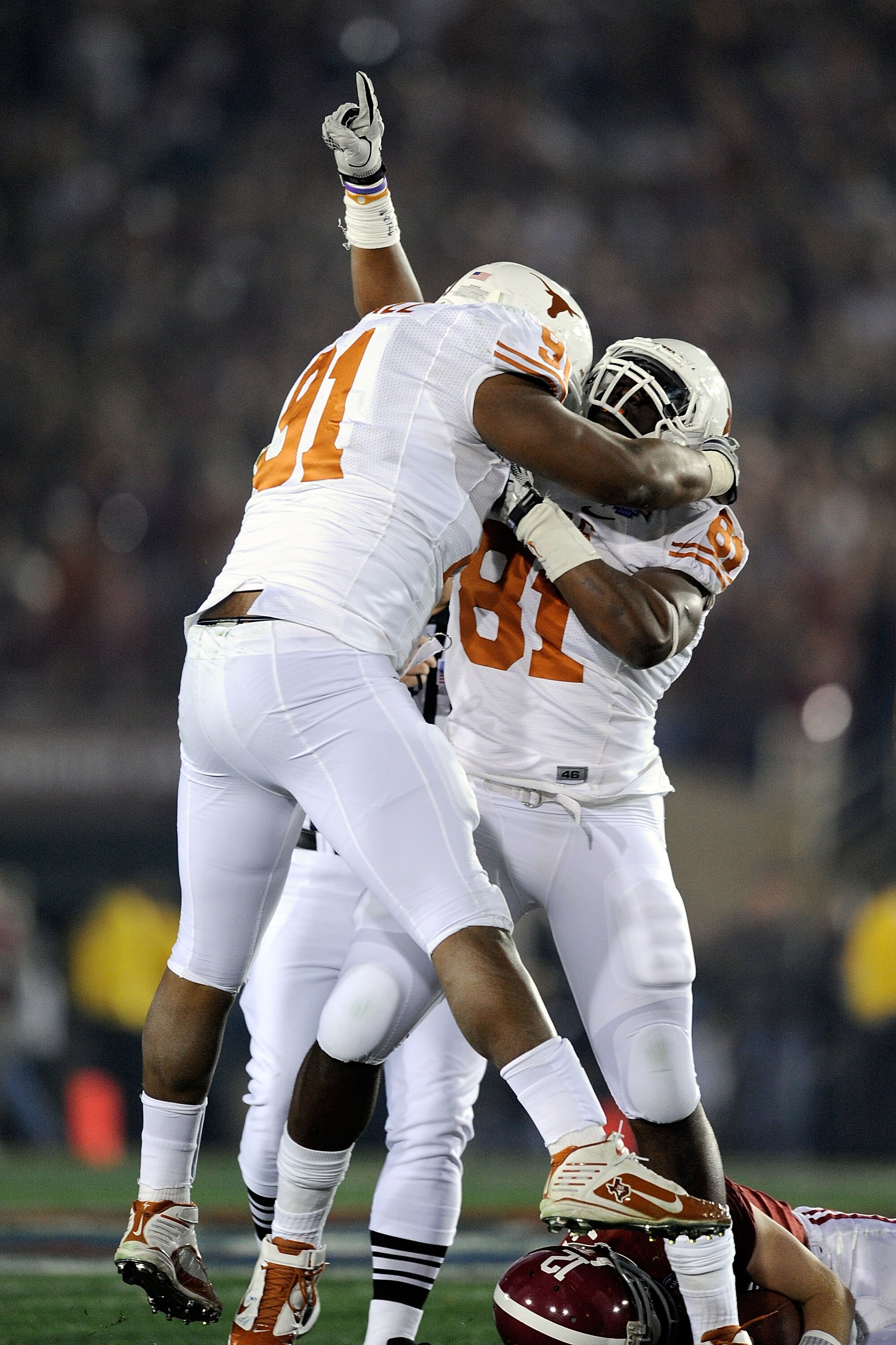 PASADENA, CA - JANUARY 07:  Defensive end Sam Acho #81 and Kheeston Randall #91 of the Texas Longhorns celebrate a sack of quarterback Greg McElroy #12 of the Alabama Crimson Tide in the first quarter of the Citi BCS National Championship game at the Rose