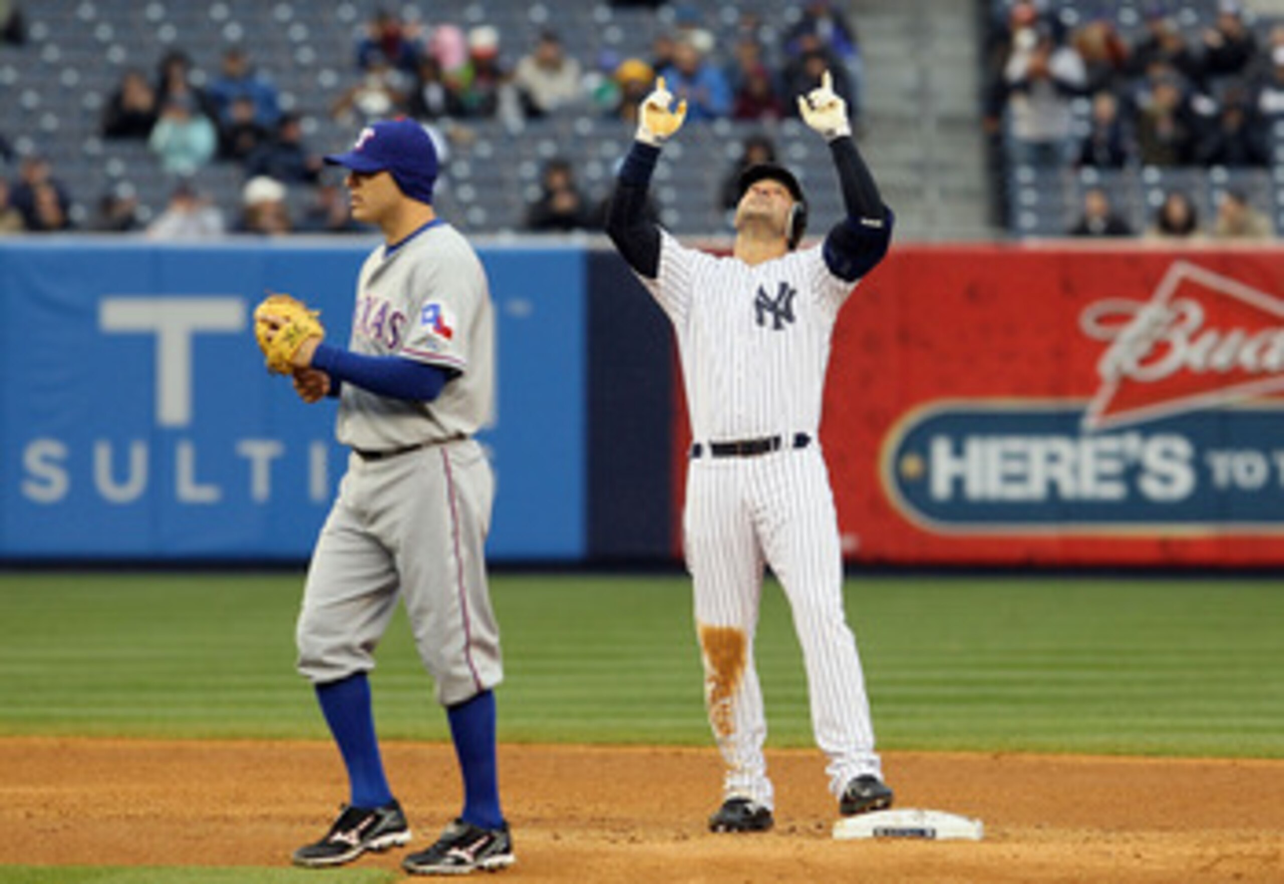 NEW YORK, NY - APRIL 16: Nick Swisher #33 of the New York Yankees celebrates a double as Ian Kinsler #5 of the Texas Rangers looks on on April 16, 2011 at Yankee Stadium in the Bronx borough of New York City.  (Photo by Jim McIsaac/Getty Images)