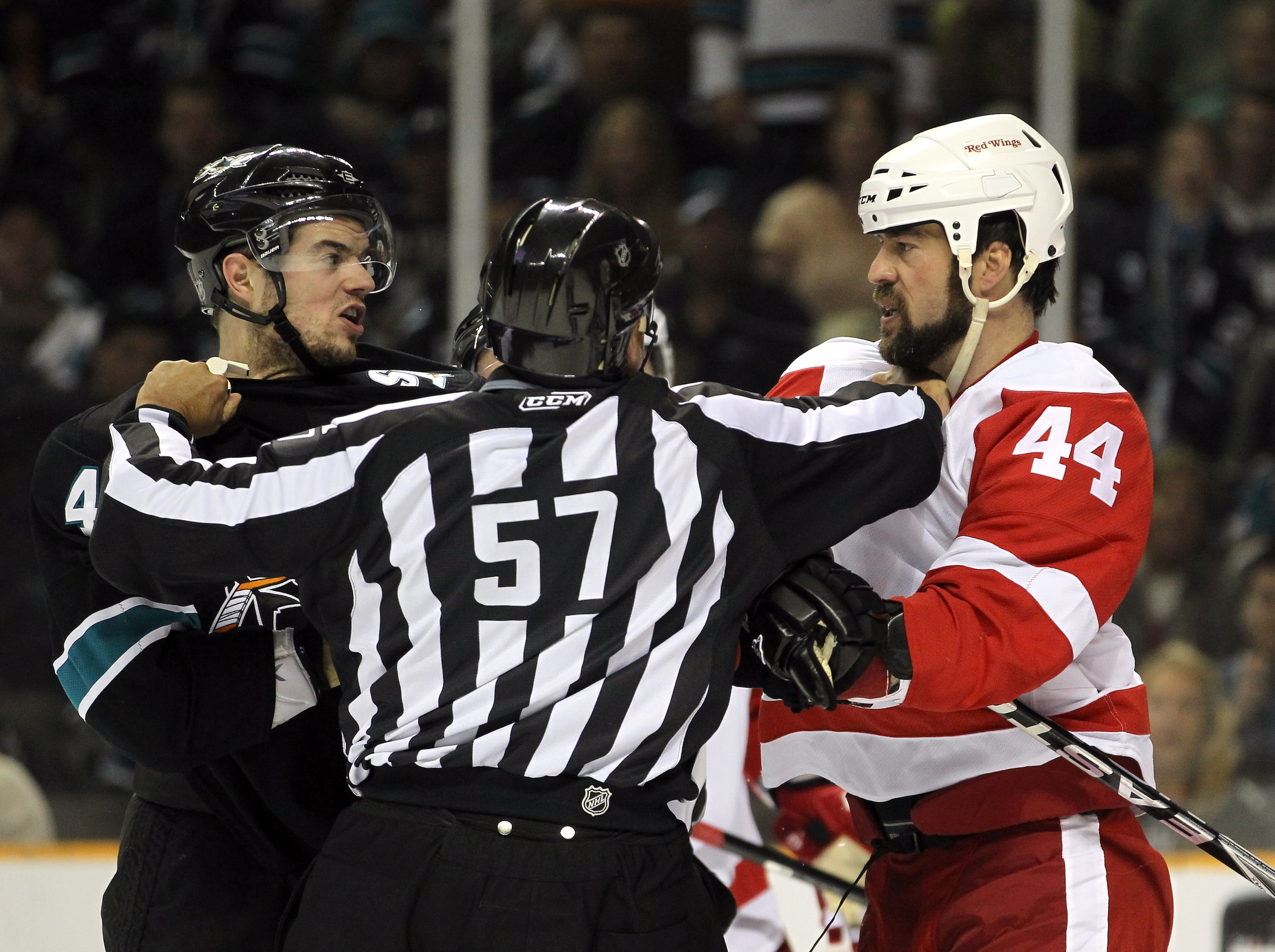 SAN JOSE, CA - MAY 01:  Marc-Edouard Vlasic #44 of the San Jose Sharks and Todd Bertuzzi #44 of the Detroit Red Wings are separated by lineman Jay Sharrers in Game Two of the Western Conference Semifinals during the 2011 NHL Stanley Cup Playoffs at HP Pav