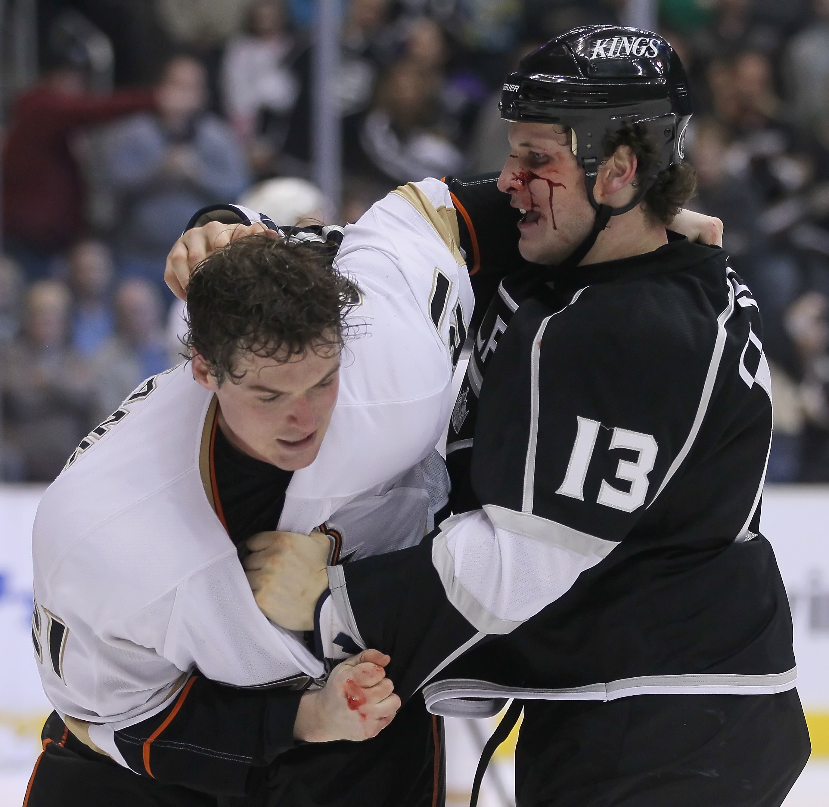 LOS ANGELES, CA - APRIL 09:  Kyle Clifford #13 of the Los Angeles Kings throws a punch at Sheldon Brookbank #21 of the Anaheim Ducks in the third period at Staples Center on April 9, 2011 in Los Angeles, California. The Ducks defeated the Kings 3-1.  (Pho