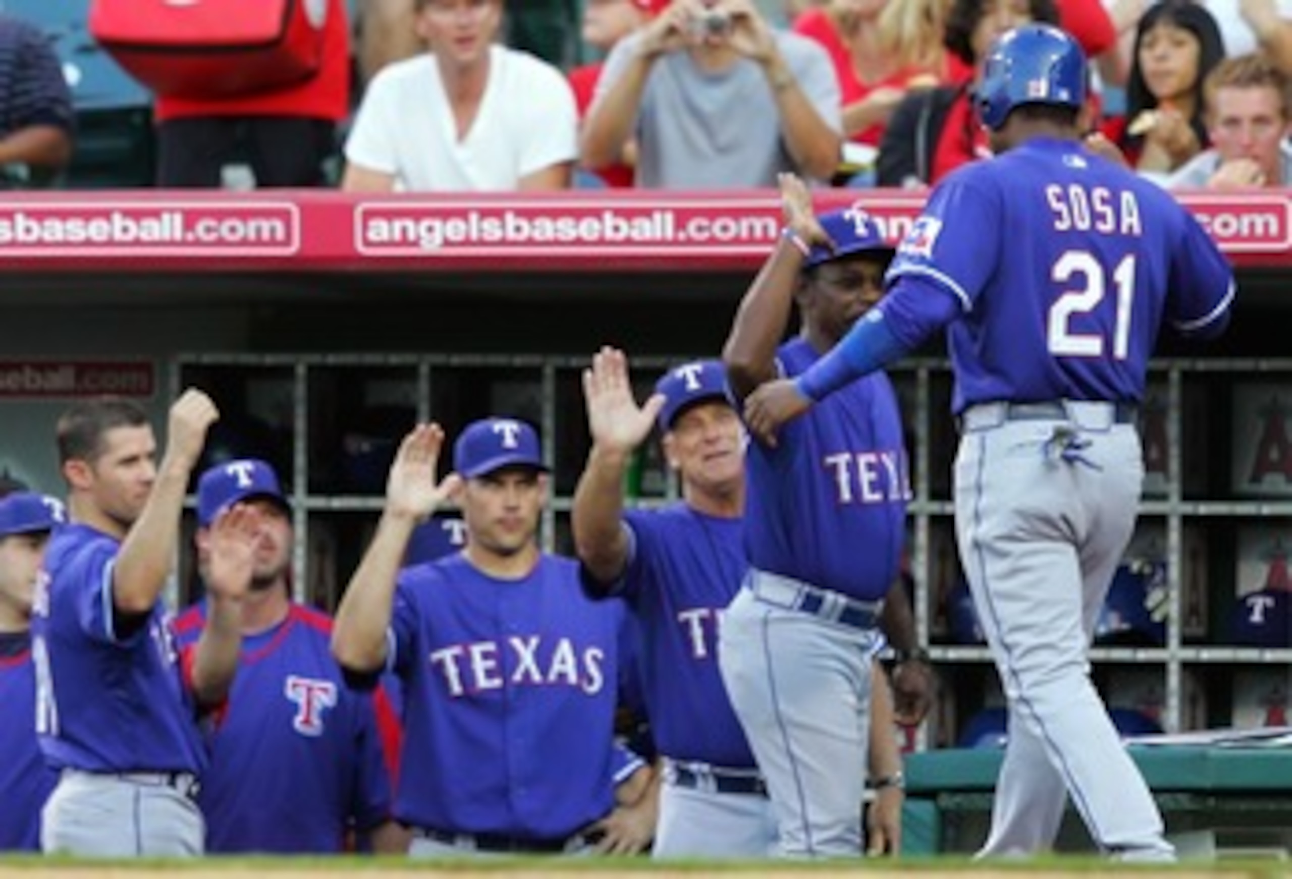 ANAHEIM, CA - JULY 14:   Sammy Sosa #21 of the Texas Rangers is congratulated by his teammates after scoring in the third inning against the Los Angeles Angels of Anaheim at Angels Stadium on July 14, 2007 in Anaheim, California.  (Photo by Lisa Blumenfel