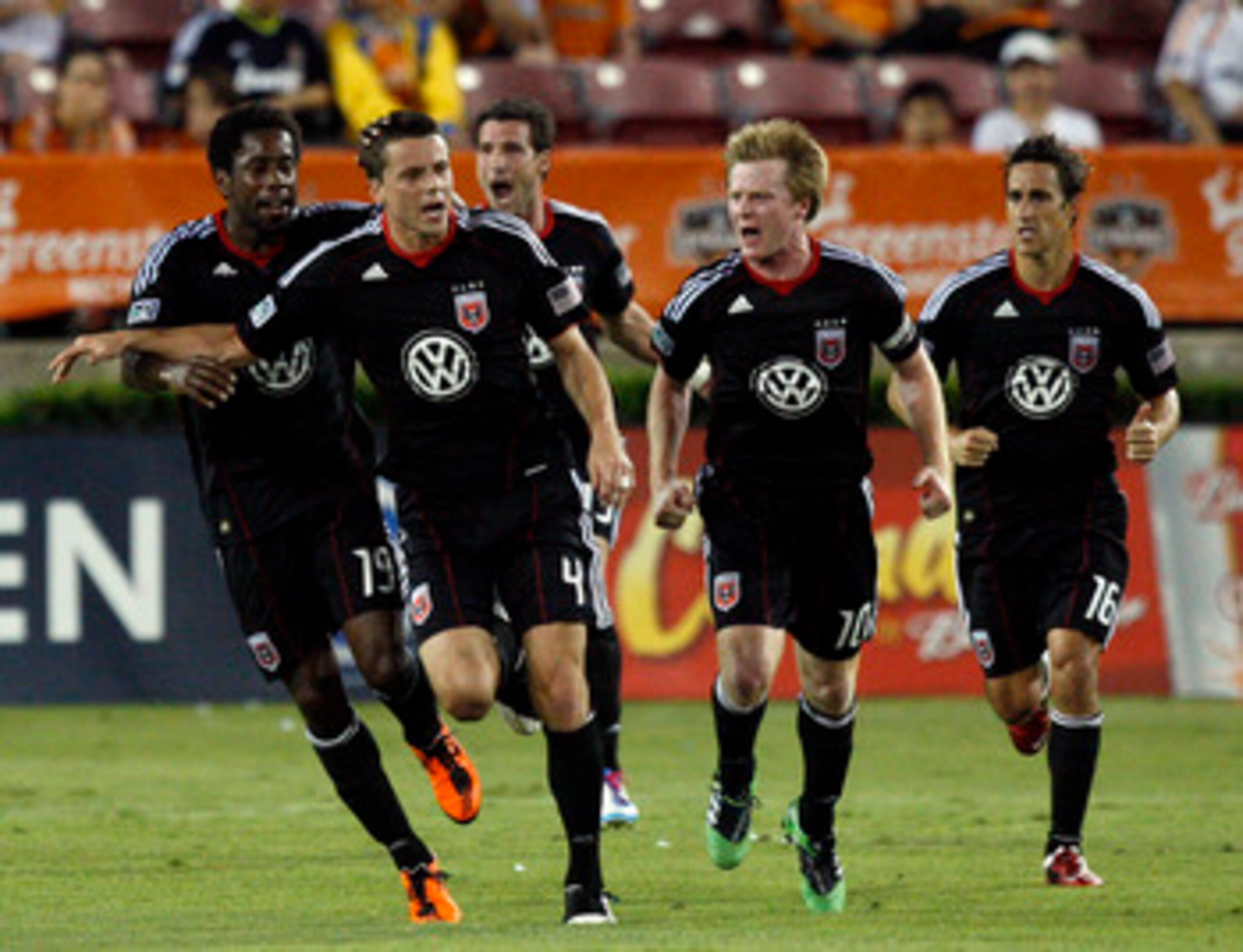 HOUSTON - APRIL 29:  Marc Burch #4 of D.C. United  celebrates with Clyde Simms #19, Dax McCarthy #10 and Josh Wolff #16 after scoring in the first half against Houston Dynamo at Robertson Stadium on April 29, 2011 in Houston, Texas.  (Photo by Bob Levey/G