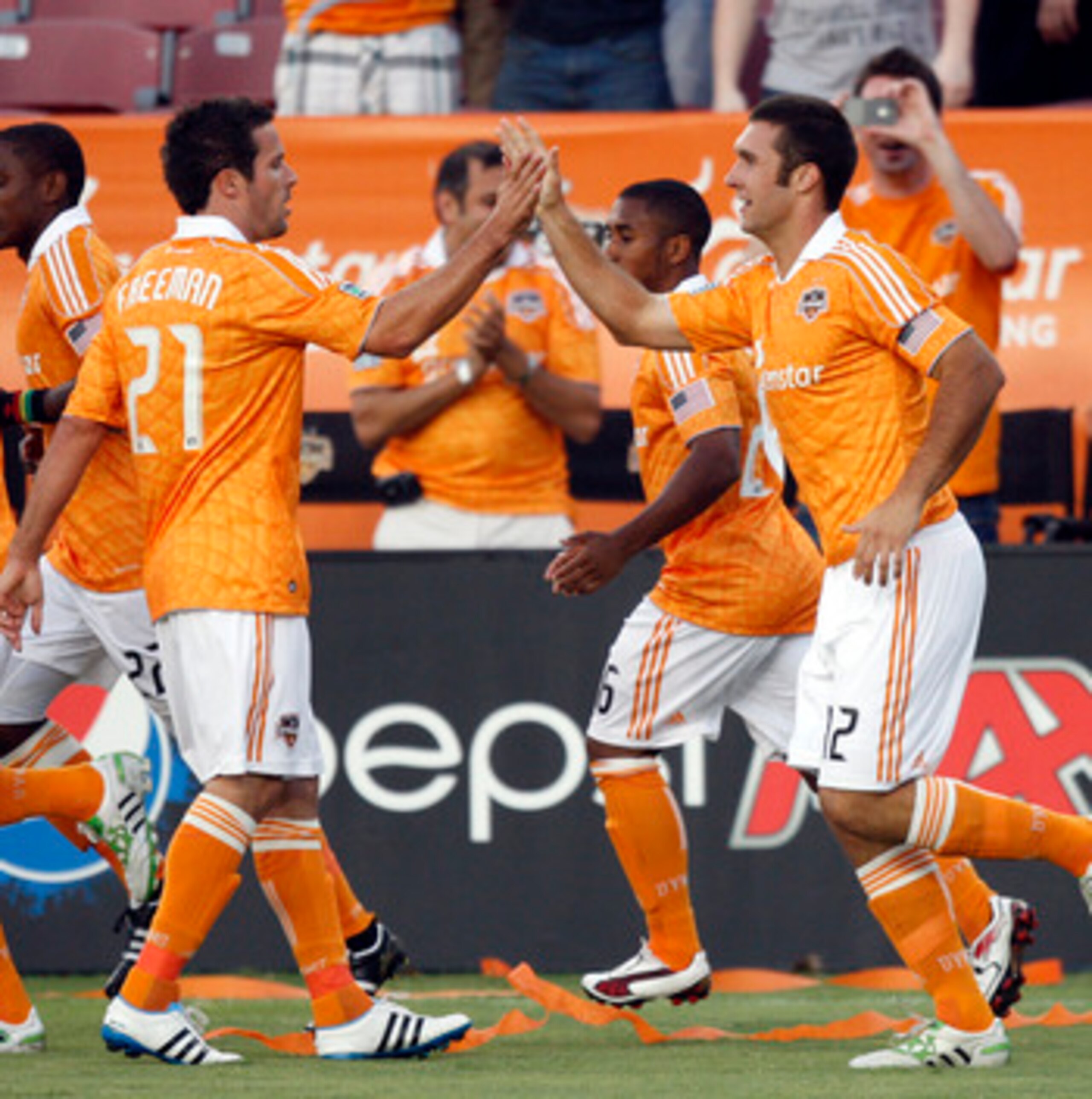 HOUSTON - APRIL 29:  Forward Will Bruin #12 of the Houston Dynamo is congratulated by Hunter Freeman #21after scoring in the first half against D.C. United at Robertson Stadium on April 29, 2011 in Houston, Texas.  (Photo by Bob Levey/Getty Images)