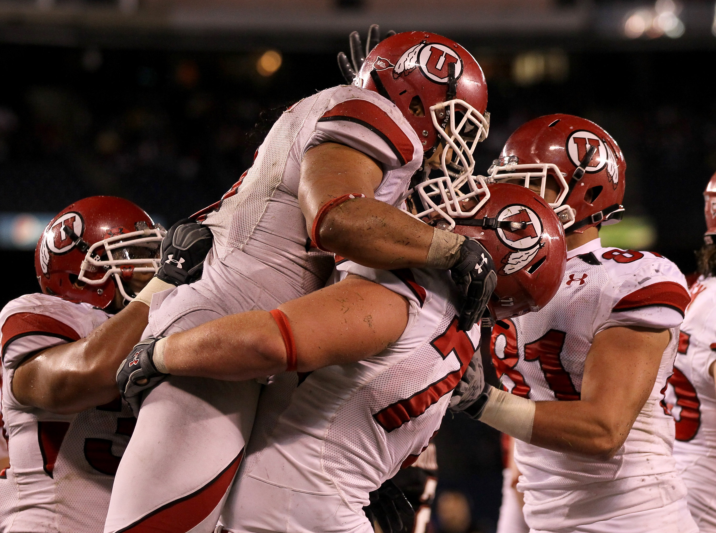 SAN DIEGO - NOVEMBER 20:  Running back Matt Asiata #4 and center Zane Taylor #77 of the Utah Utes  celebrate Asiata's one yard touchdown run against the San Diego State Aztecs in the fourth quarter at Qualcomm Stadium on November 20, 2010 in San Diego, Ca