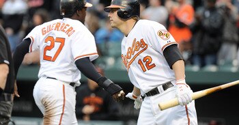 BALTIMORE, MD - APRIL 09:  Vladimir Guerrero #27 of the Baltimore Orioles is congratulated by Mark Reynolds #12 after scoring against the Texas Rangers at Oriole Park at Camden Yards on April 9, 2011 in Baltimore, Maryland.  (Photo by Greg Fiume/Getty Ima