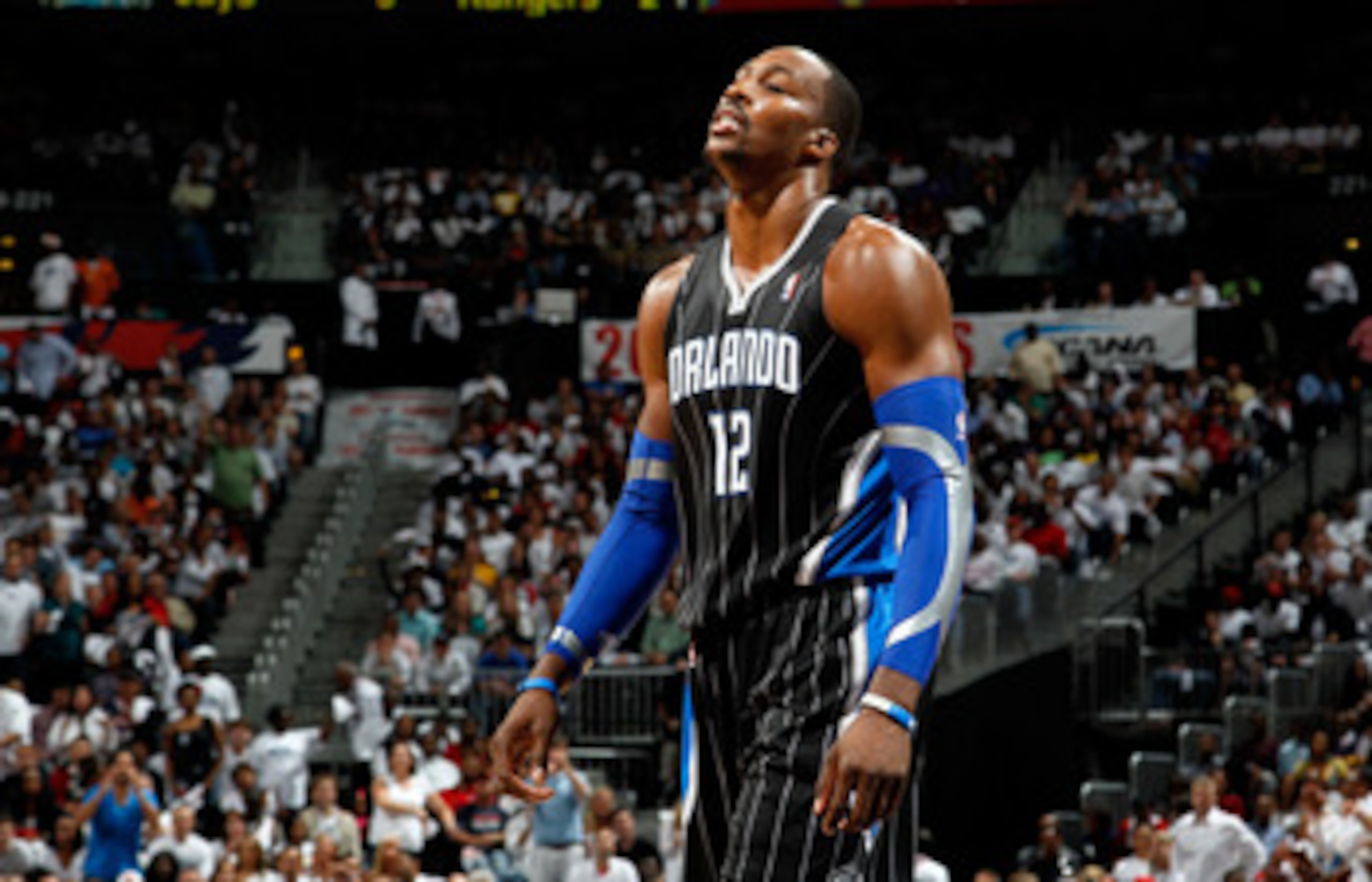 ATLANTA, GA - APRIL 28:  Dwight Howard #12 of the Orlando Magic walks to the bench after a turnover to the Atlanta Hawks during Game Six of the Eastern Conference Quarterfinals in the 2011 NBA Playoffs at Philips Arena on April 28, 2011 in Atlanta, Georgi