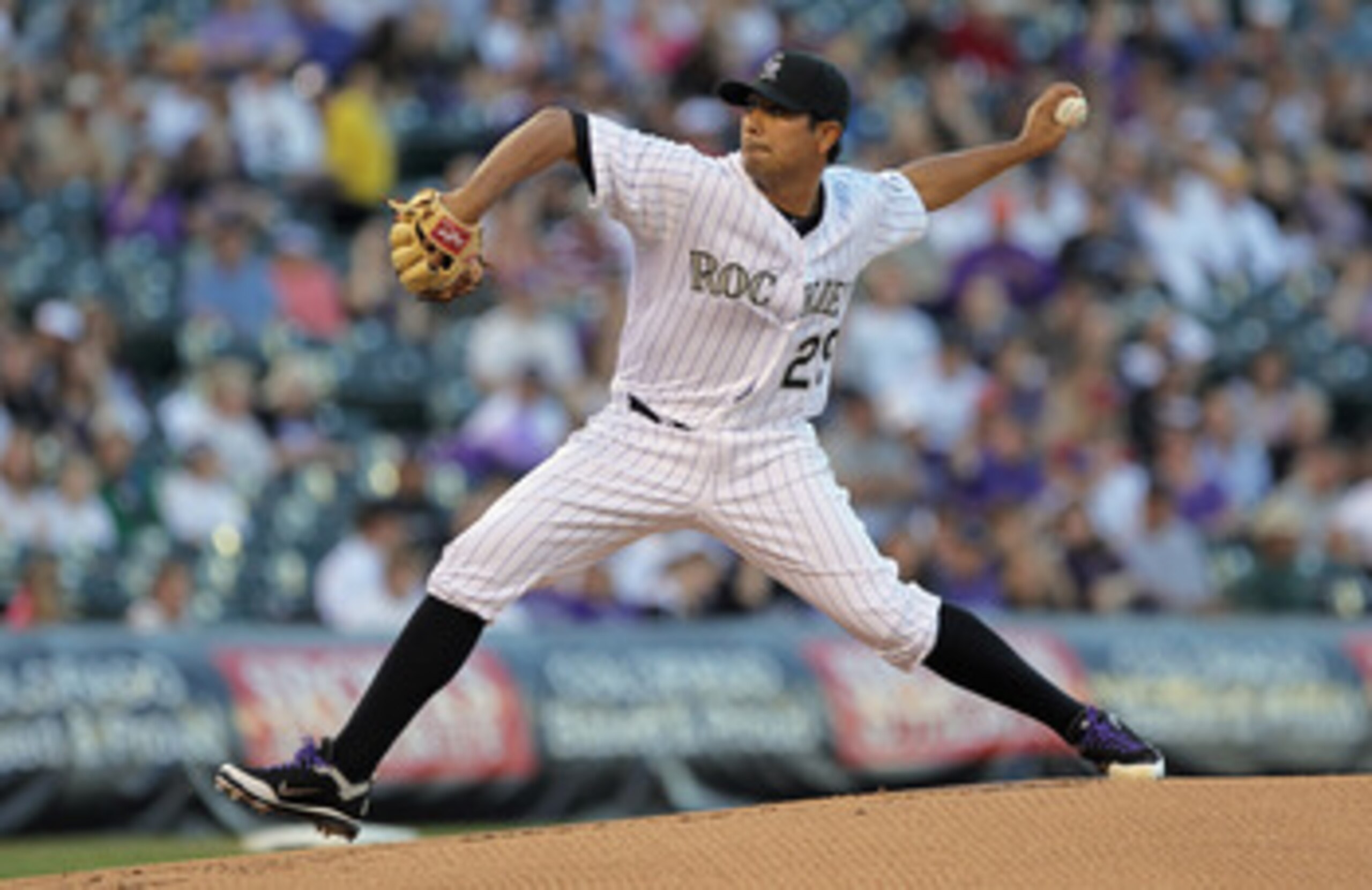 DENVER, CO - APRIL 02:  Starting pitcher Jorge De La Rosa #29 of the Colorado Rockies delivers against the Arizona Diamondbacks at Coors Field on April 2, 2011 in Denver, Colorado.  (Photo by Doug Pensinger/Getty Images)