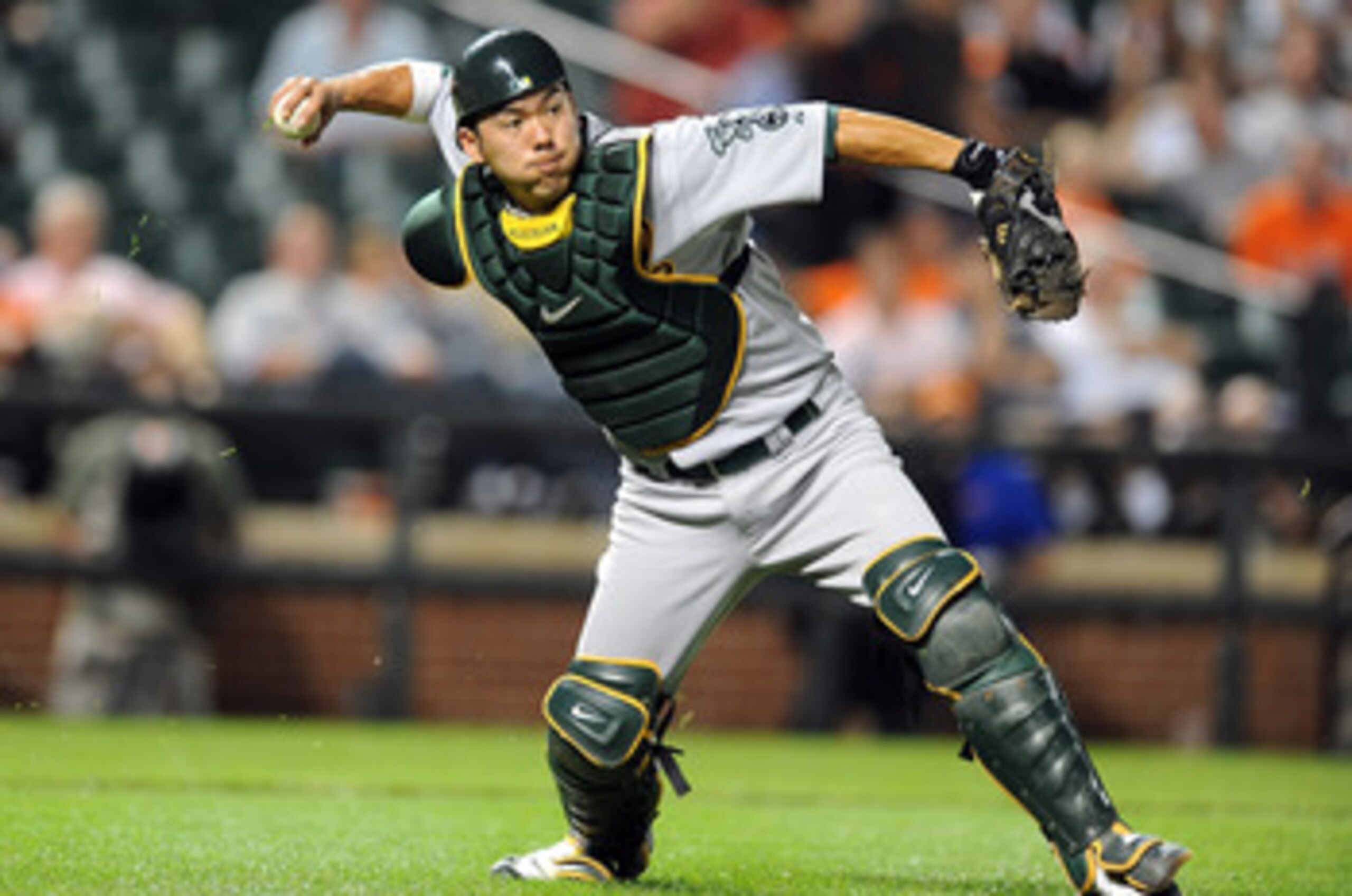 BALTIMORE - MAY 26:  Kurt Suzuki #8 of the Oakland Athletics throws the ball to first base against the Baltimore Orioles at Camden Yards on May 26, 2010 in Baltimore, Maryland.  (Photo by Greg Fiume/Getty Images)
