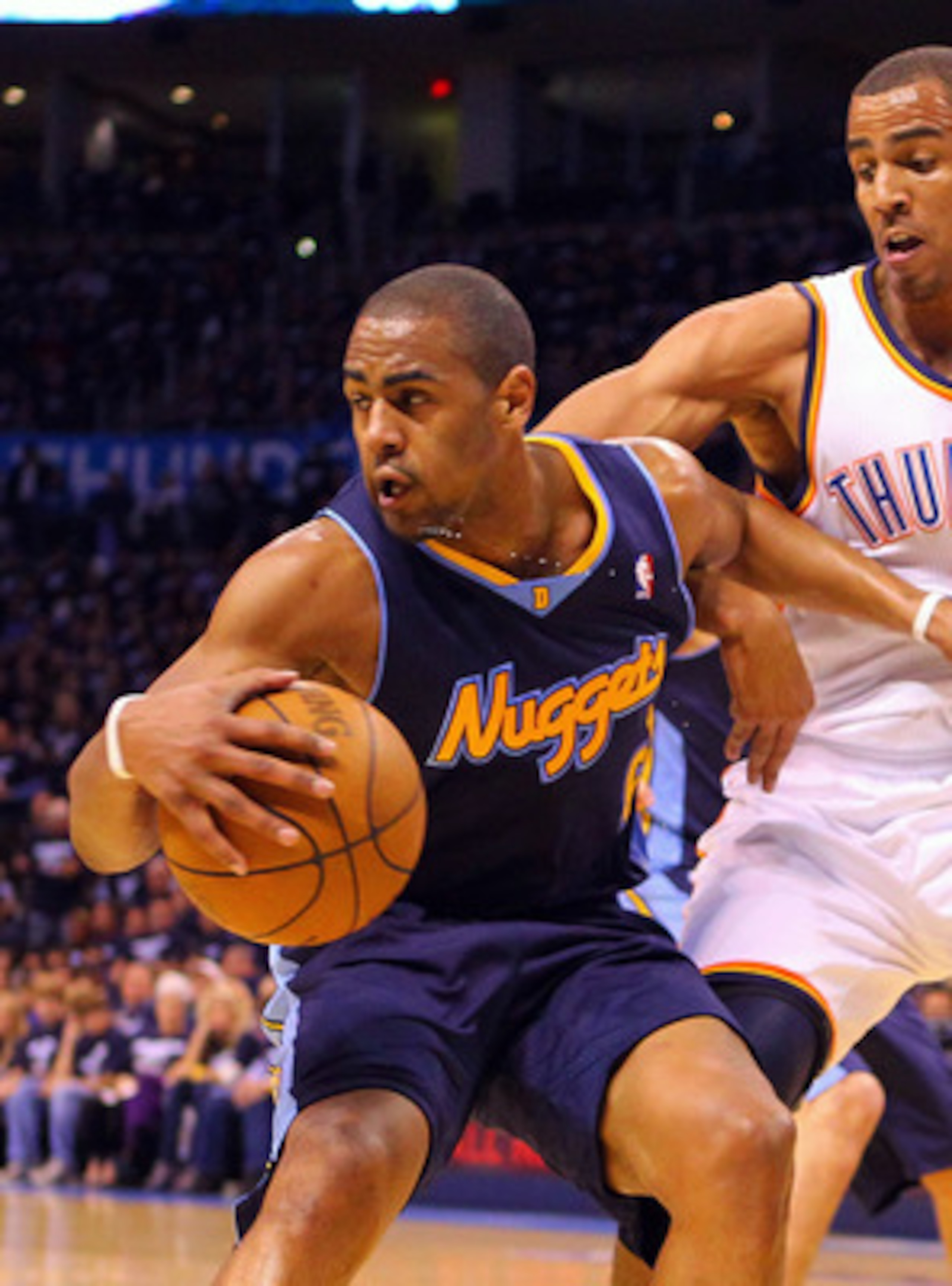 OKLAHOMA CITY, OK - APRIL 27: Arron Afflalo #6 of the Denver Nuggets looks to get past Thabo Sefolosha #2 of the Oklahoma City Thunder in Game Five of the Western Conference Quarterfinals in the 2011 NBA Playoffs on April 27, 2011 at the Ford Center in Ok