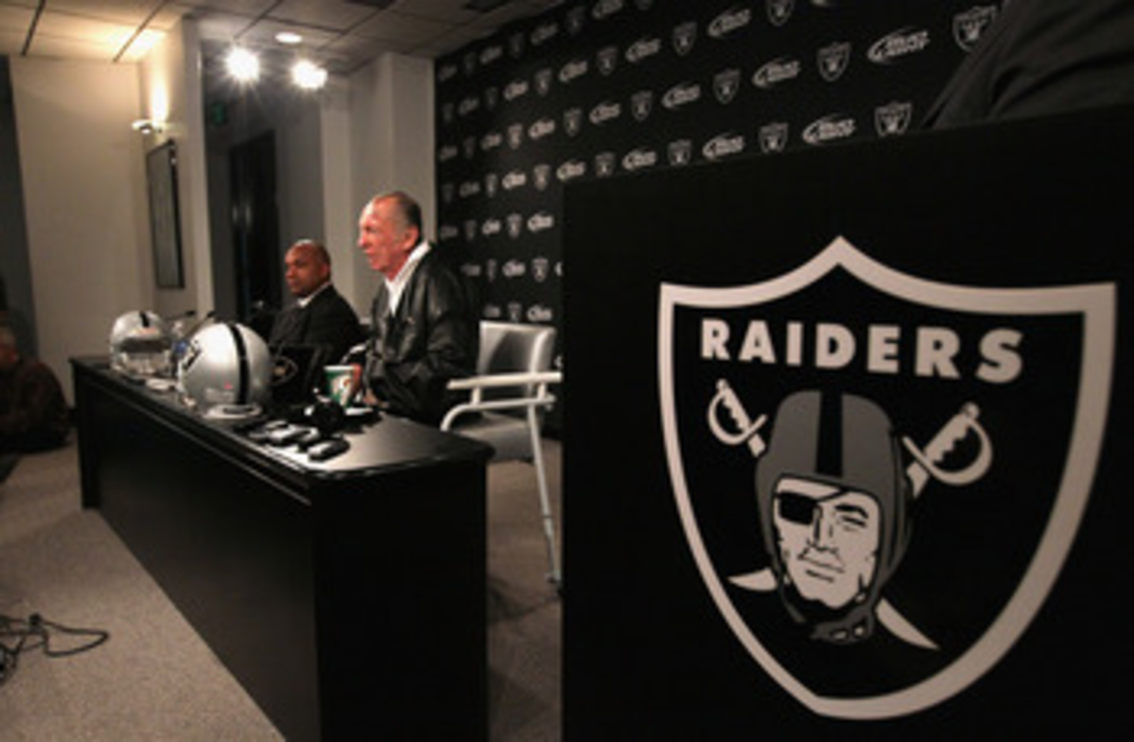 ALAMEDA, CA - JANUARY 18:  New Oakland Raiders coach Hue Jackson (L) looks on as Raiders owner Al Davis speaks during a press conference on January 18, 2011 in Alameda, California. Hue Jackson was introduced as the new coach of the Oakland Raiders, replac